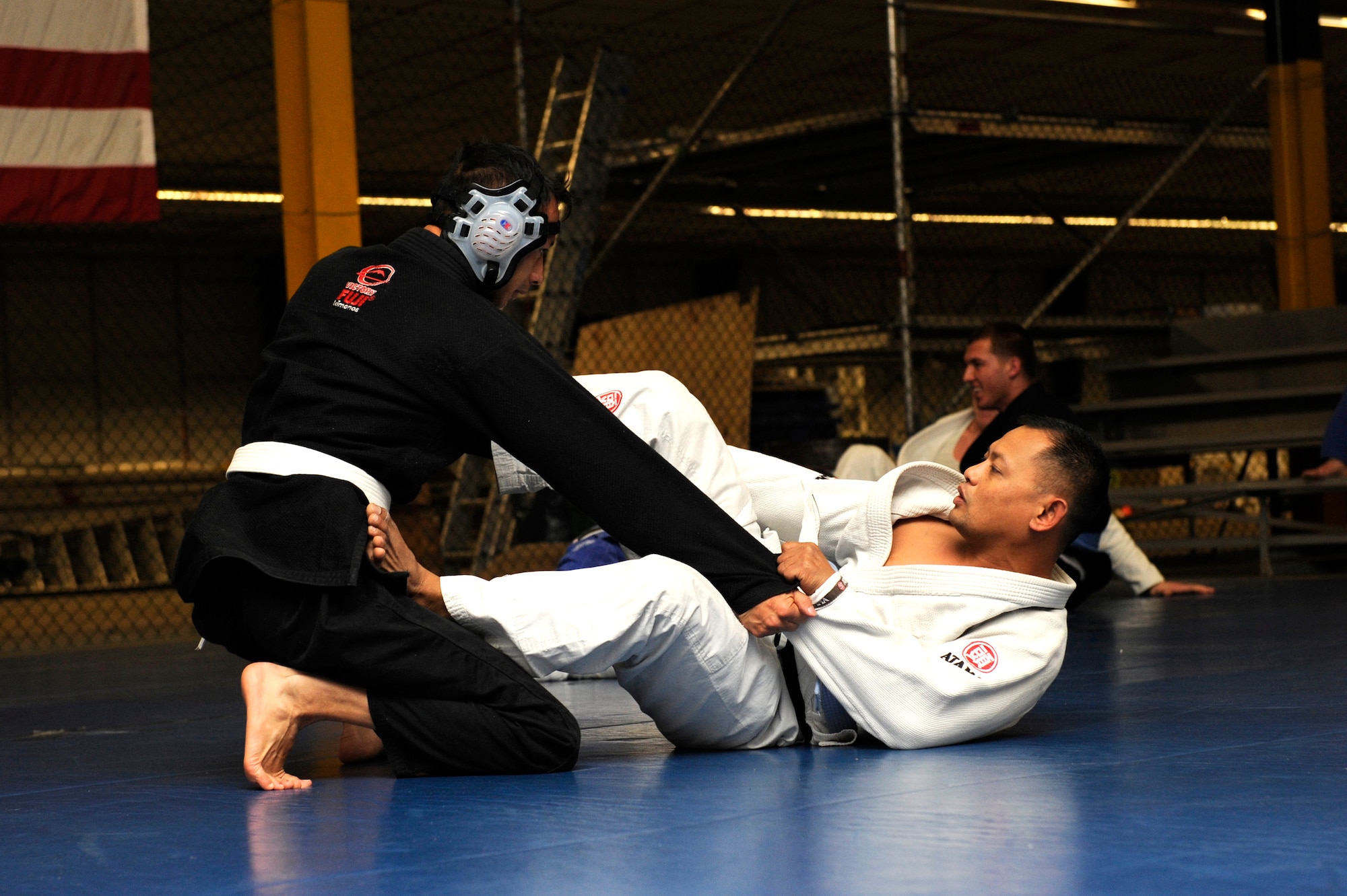 Students of the Brazilian Jiu-jitsu class spar and practice throwing during a class at Rhines Ordnance Barracks Germany, Nov. 26, 2012. Students here go over different self-defense techniques. Many different people come through the class all with different skill levels.  Some people practice Jujitsu for the technique, others for fitness or even just for self-defense. Classes are every Monday and Wednesday at 6 p.m. to 8 p.m. (U.S. Air Force photo/ Senior Airman Aaron-Forrest Wainwright) 