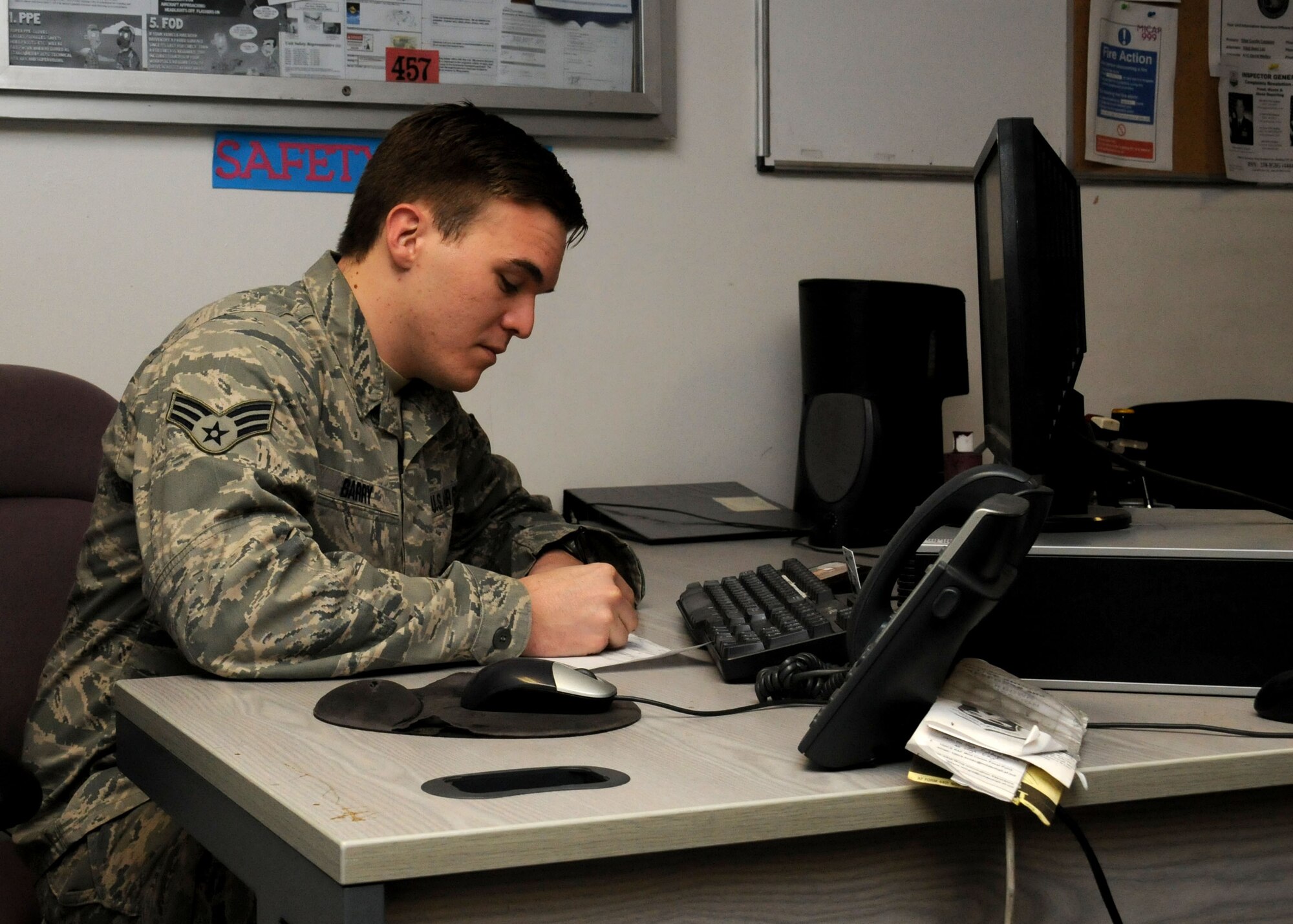 Senior Airman Philip Barry, 100th Logistics Readiness Squadron aircraft parts store technician, from Big Bend, Swaziland, Africa, fills out an Air Force form 2005 Dec. 14, 2012, at RAF Mildenhall, England. Other sections in the Material Management Flight include customer service, equipment management, flight service center, hazardous material pharmacy and mobility. (U.S. Air Force photo by Gina Randall/Released)
