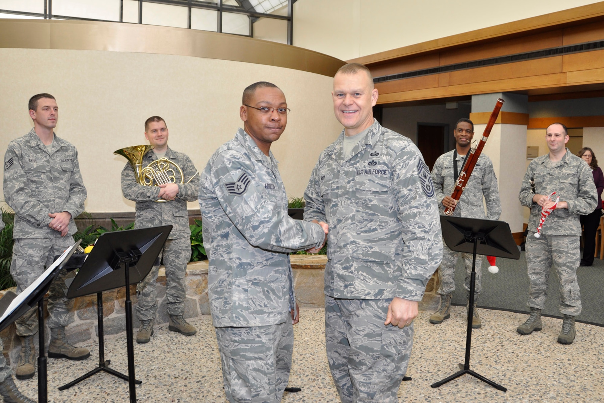 Chief Master Sgt. of the Air Force James A. Roy coins Staff Sgt. William White, 512th Memorial Affairs Squadron, for his work at the mortuary. Roy came to the Charles C. Carson Center for Mortuary Affairs as part of his farewell tour Dec. 12, 2012, to thank the men and women for their service to fallen heroes and their families. Roy, the 16th Chief Master Sergeant of the Air Force, will retire next month after more than 30 years of service. (U.S. Air Force photo/Master Sgt. Cherie McNeill)
