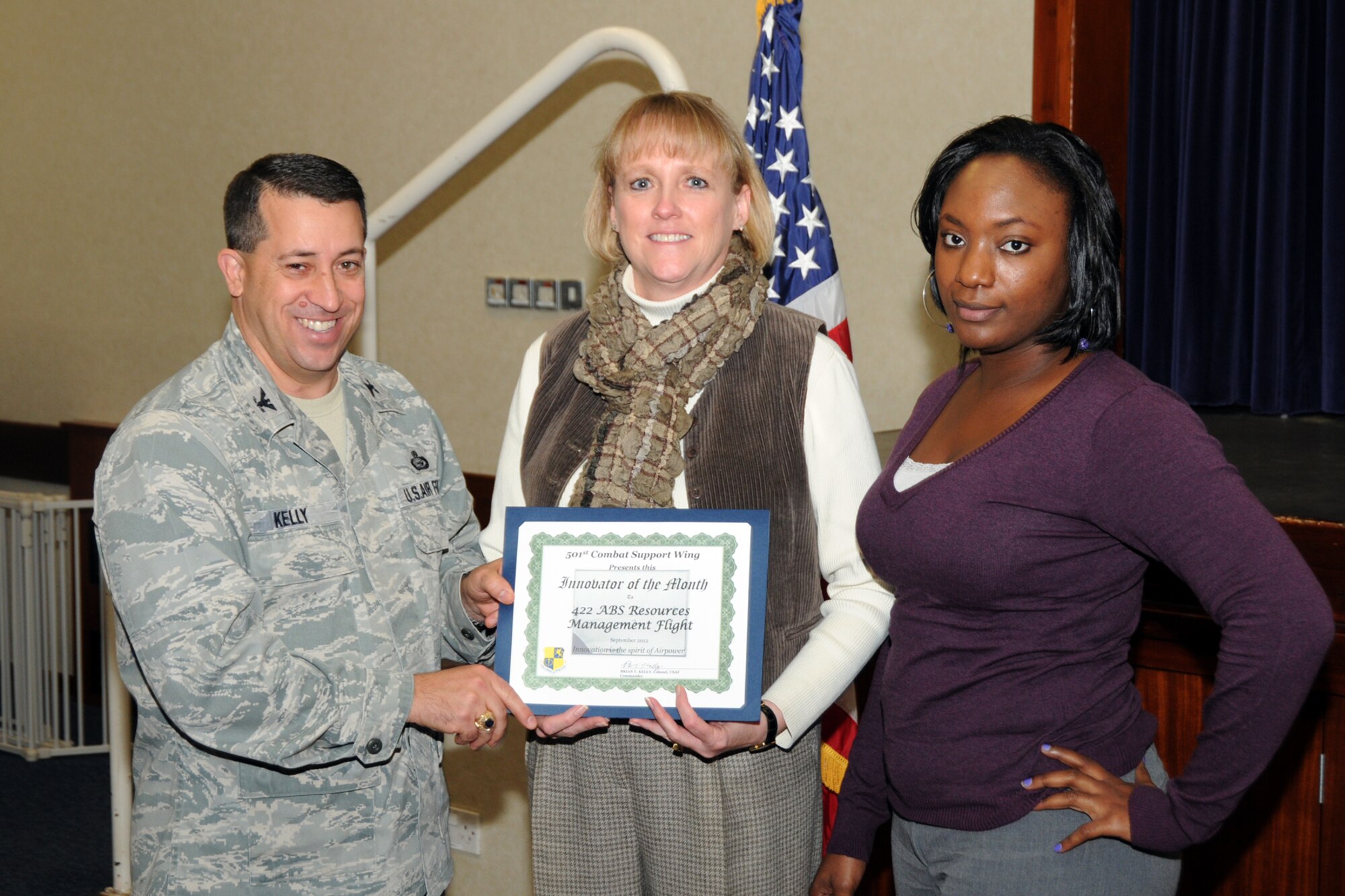 RAF CROUGHTON, United Kingdom -- (From left) Col. Brian Kelly, 501st Combat Support Wing commander, presents Janice Hollen and Andrea Brown, 422nd Air Base Squadron Resource Management Flight, with the Innovator of the Month Award at RAF Croughton, Oct. 25. The resource management flight merged the 420th ABS and 422nd ABS nonappropriated fund instrumentalities, saving nearly $141,000 in morale, welfare and recreation funds for use to improve quality of life at 422nd Air Base Group installations. (U.S. Air Force photo by Master Sgt. Randy Hillsgrove)