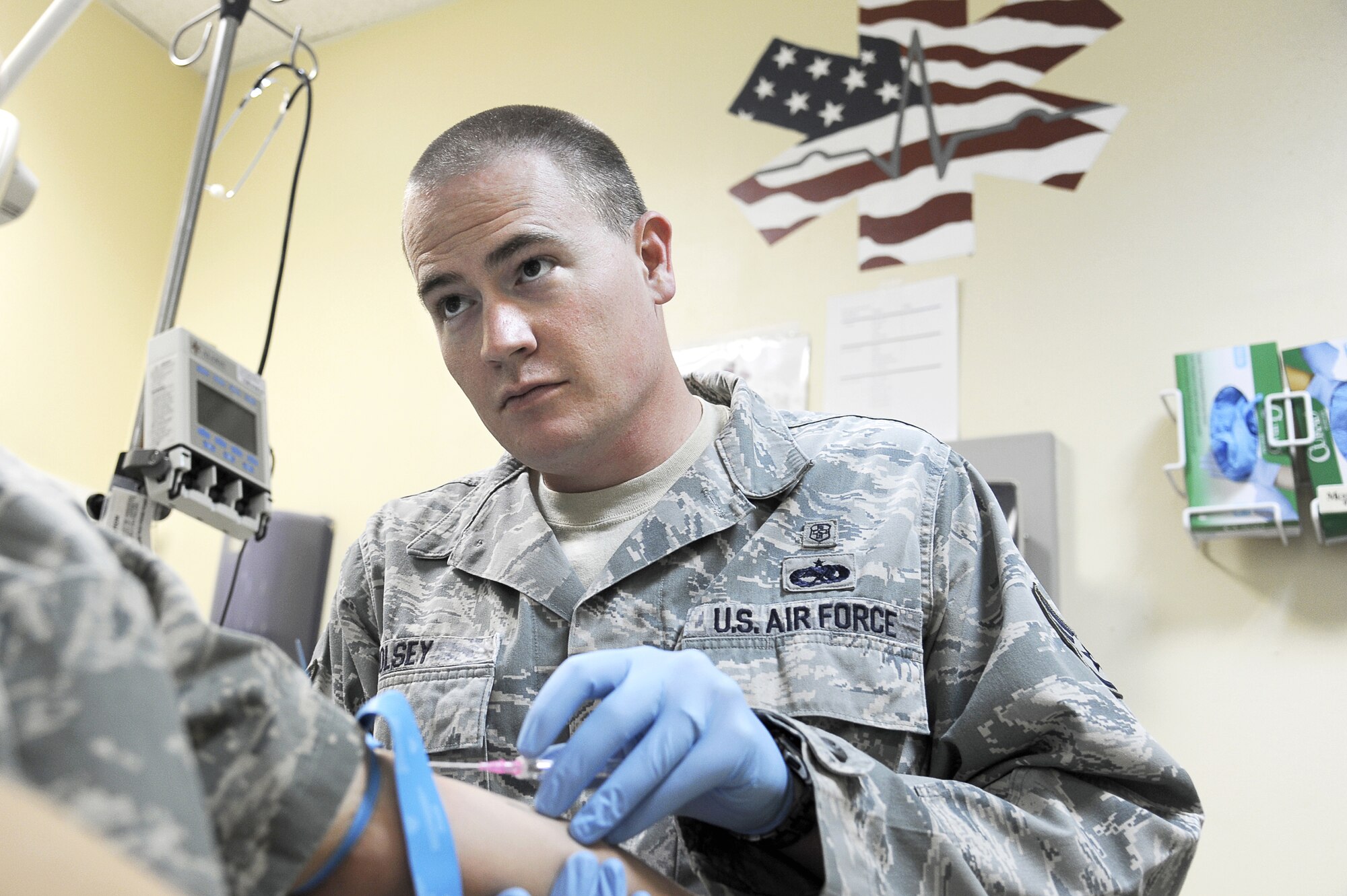 Staff Sgt. Kenneth Holsey, 386th Expeditionary Medical Group medical
technician, draws blood from a patient at a deployed location in Southwest
Asia on Dec. 13, 2012.   Holsey was nominated as the weeks "Rock Solid
Warrior" for the 386th Air Expeditionary Wing.   (U.S. Air Force photo by
Staff Sgt. Austin Knox)
