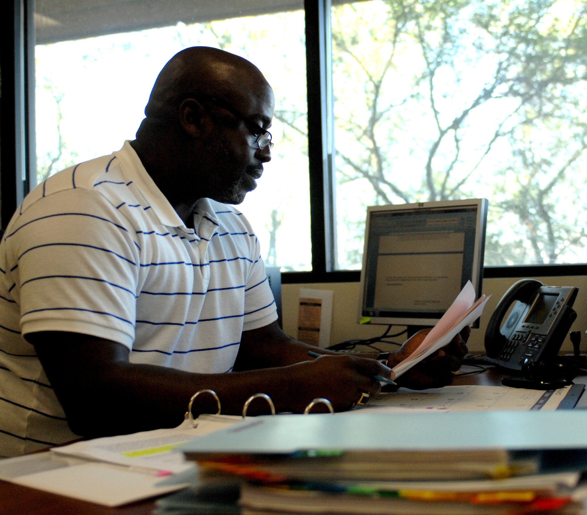 U.S. Air Force Chief Master Sgt. (Ret.) Vincent Howard reads through legal files as a volunteer member of the 355th Fighter Wing Legal Office on Davis-Monthan Air Force Base, Ariz., Dec. 10, 2012. The Legal Office accepts volunteers and interns; these members are usually tasked with performing tasks such as legal reviews on private organizations or witnessing wills. (U.S. Air Force photo by Airman 1st Class Saphfire Cook)