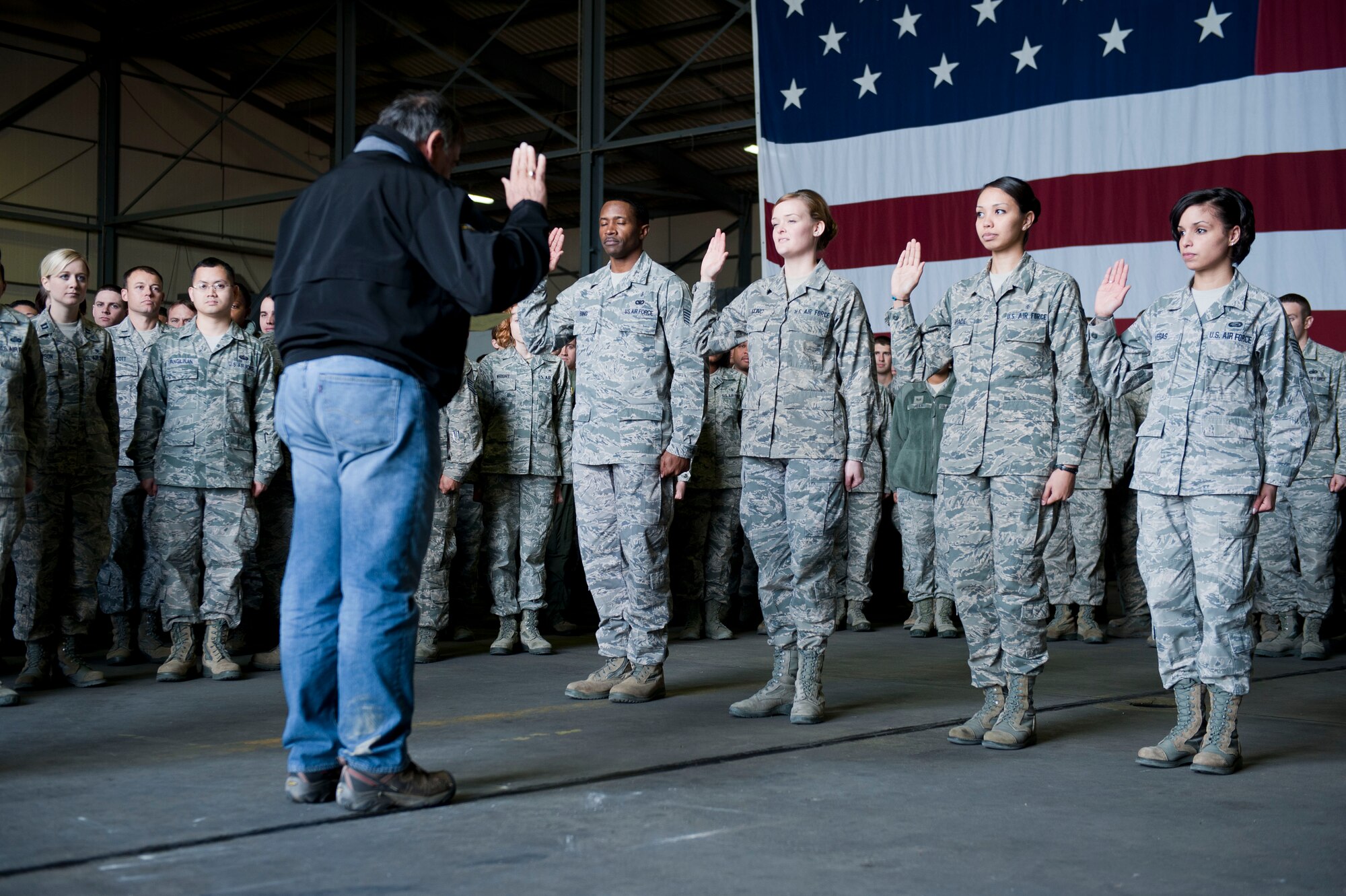 Secretary of Defense Leon Panetta administers the Oath of Enlistment to four Airmen Dec. 14, 2012, at Incirlik Air Base, Turkey. Tech. Sgt. Antonio Bing, Senior Airman Nichole Kilinc, and Staff Sgt. Blanche Shade, from the 39th Medical Group and Staff Sgt. Erica Veras, 39th Force Support Squadron, had the unique opportunity to have a reenlistment ceremony with Panetta as the presiding official. (U.S. Air Force photo by Staff Sgt. Marissa Tucker/Released)