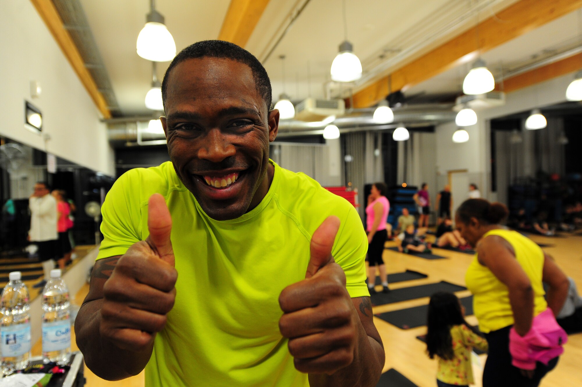Staff Sgt. Kedist Burnett, 86th Civil Engineer Squadron Airmen dorm leader and Delicious Abs class instructor, mingles before class on Ramstein Air Base, Germany, Dec. 11, 2012. Burnett makes himself accessible before and after class. (U.S. Air Force photo/Airman 1st Class Jordan Castelan)