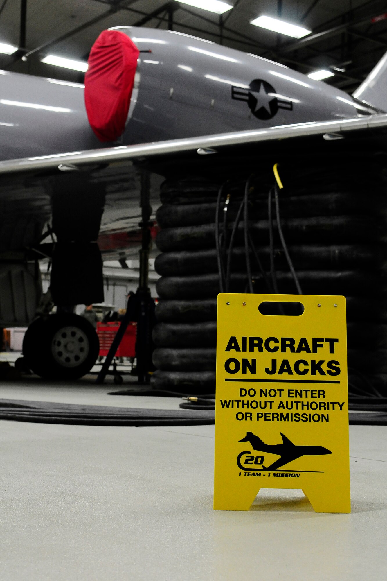 Responding to a malfunctioning jack, the crashed, damaged, and disabled aircraft recovery team executes an extremely sensitive procedure in order to avoid potential damage to a C-20 on Ramstein Air Base, Germany, Dec. 10, 2012. The black rubber aircraft lifting bags are used to lift the aircraft and replace the malfunctioning jack. (U.S. Air Force photo/Airman 1st Class Hailey Haux)