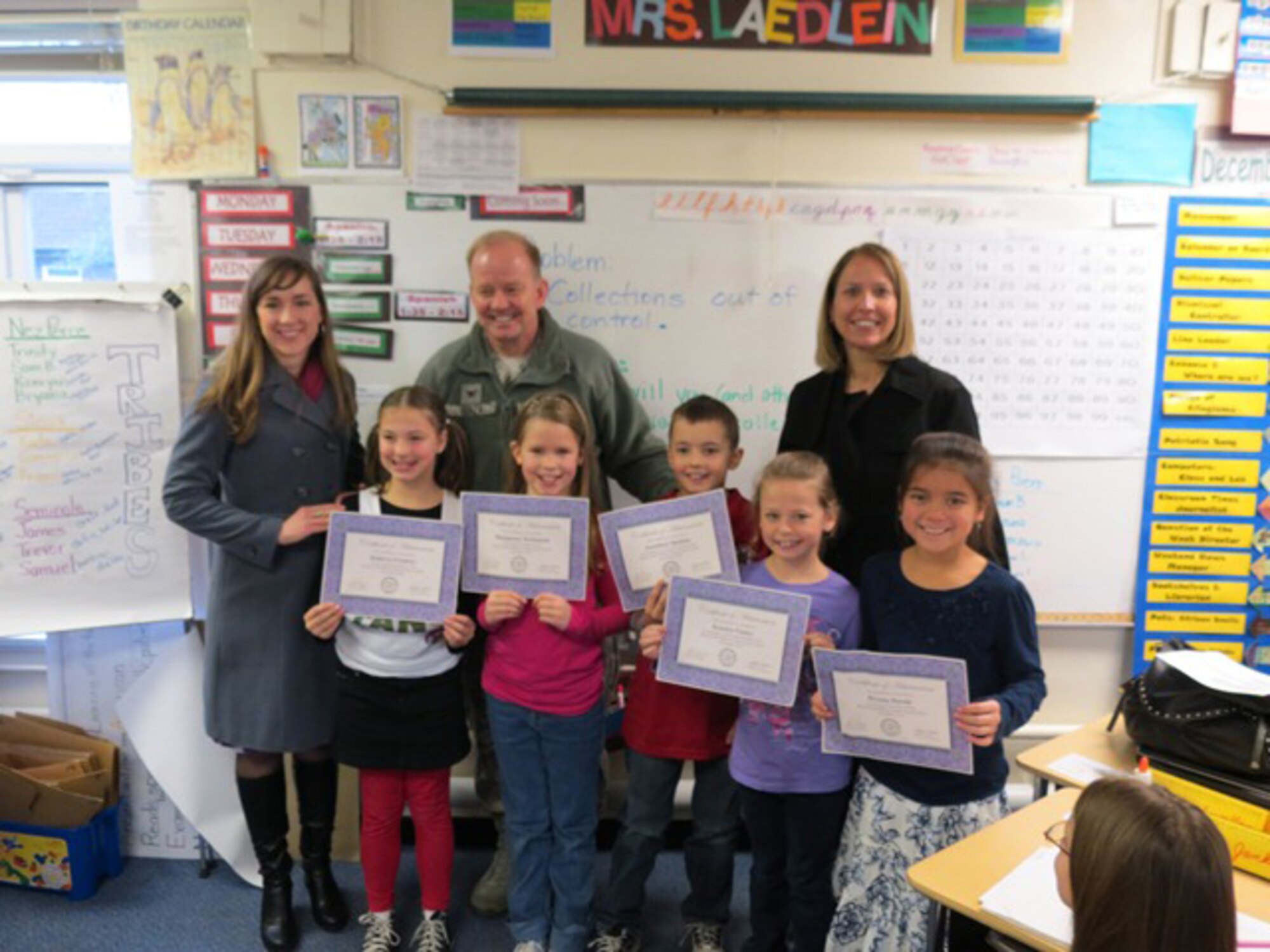ROYAL AIR FORCE FELTWELL, England - Feltwell Elementary School kindergarten through third grade essay contest winners pose for a photo with Col. Scott Benza, 48th Mission Support Group commander, and members of the RAF Lakenheath/Mildenhall School Liaison Office. (Courtesy Photo) 