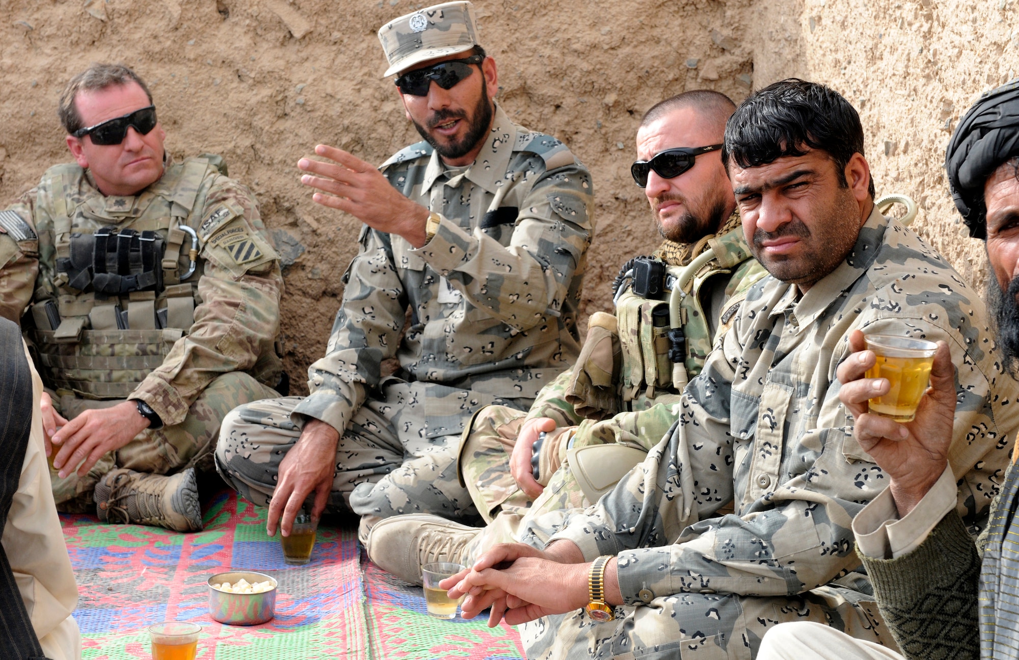 From left, Lt. Col. Scott Sill, an Afghan hand and senior mentor with Security Forces Assistance Team 11, Maj. Asmatulla Safi, an operations officer with 3rd Zone Afghan Border Police, Lt. Col. Ekland Dauti, commander of Contingent Eagle Five of the Albanian Special Operations Force, conduct a village shura with Afghan Border Police members and villagers of Mawlazay during Operation Southern Strike IV, Kandahar province, Afghanistan, Nov. 17, 2012. (U.S. Army Photo/Staff Sgt. Ryan Sheldon)