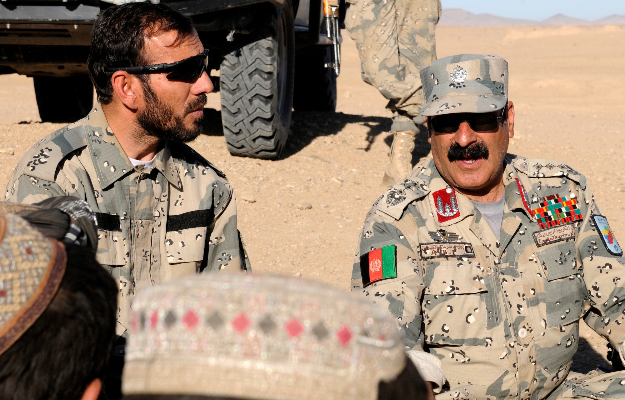 From left, 3rd Zone Afghan Border Police members, Maj. Asmatulla Safi, an operations officer and Col. Fasil Karim Karimi, chief of staff, conduct a shura in the village of Gagre Naw, Afghanistan, during Operation Southern Strike IV, Nov. 18, 2012. The operation involved collaboration between members of the Afghan Air Force, the 3rd Zone Afghan Border Police and their respective Security Forces Assistance Team, providing security for the mission. (U.S. Army Photo/Staff Sgt. Ryan Sheldon)
