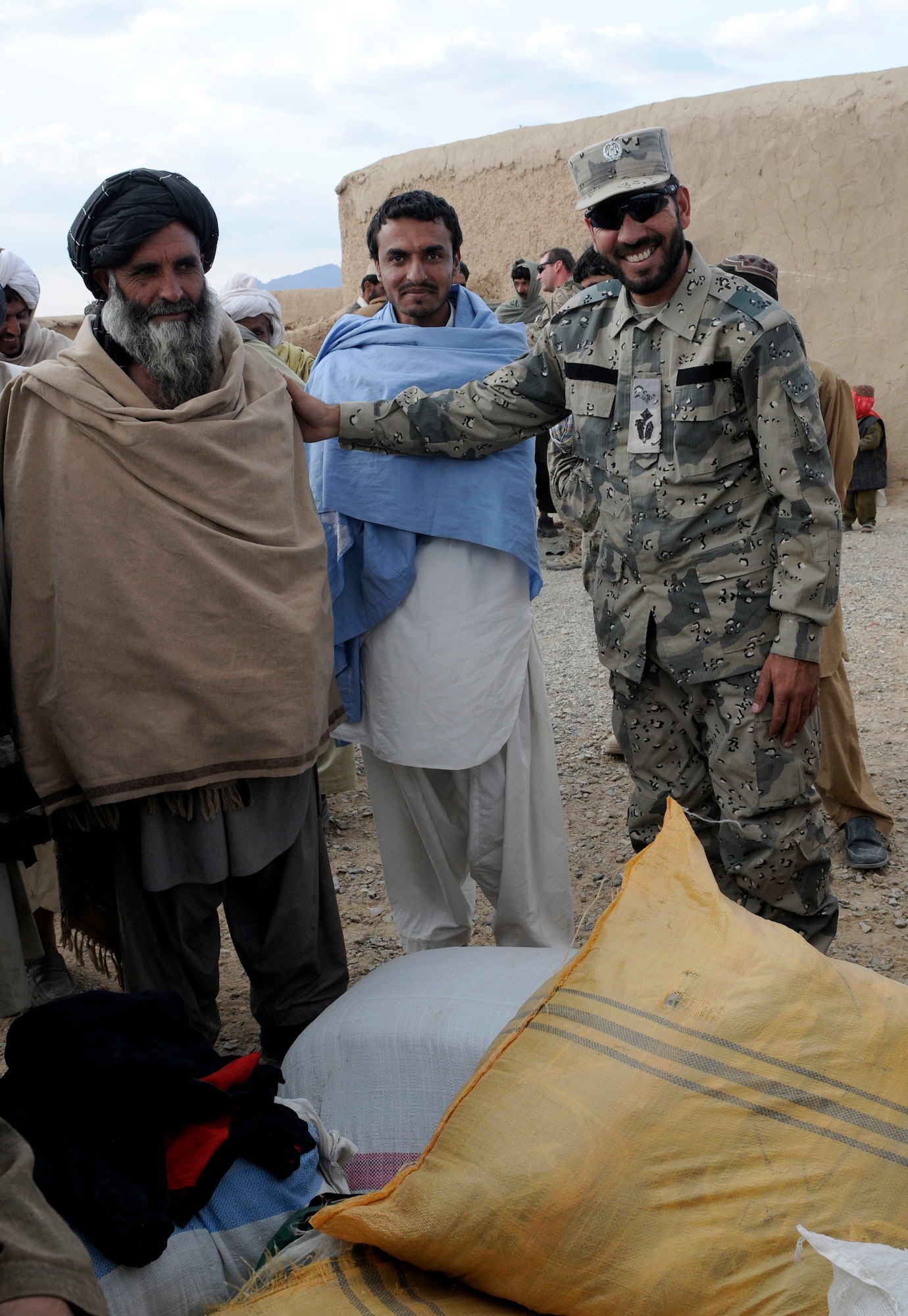 Maj. Asmatulla Safi (right), an operations officer with 3rd Zone Afghan Border Police poses with a village elder in Mawlazay, Afghanistan, during Operation Southern Strike IV, Nov. 17, 2012. More than 4,400 pounds of flour, rice, blankets and clothing were delivered to remote villages in Spin Boldak and Tak-the Pol Districts by Afghan Air Force Kandahar Air Wing Mi-17 helicopter crew members and the Afghan Border Police. (U.S. Army Photo/Staff Sgt. Ryan Sheldon)