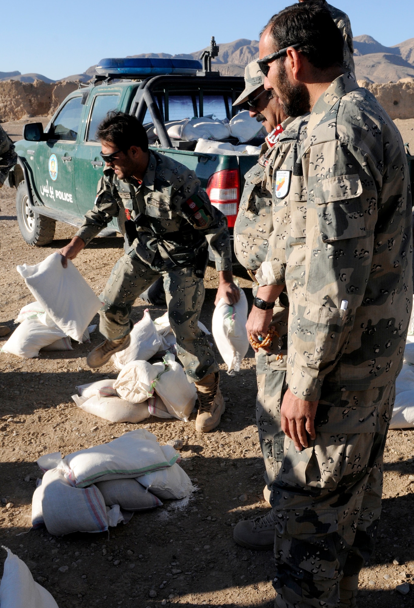 Members of the 3rd Zone Afghan Border Police separate humanitarian aid for the villagers of Gagre Naw, Afghanistan, during Operation Southern Strike IV, Nov. 18, 2012. (U.S. Army Photo/Staff Sgt. Ryan Sheldon)