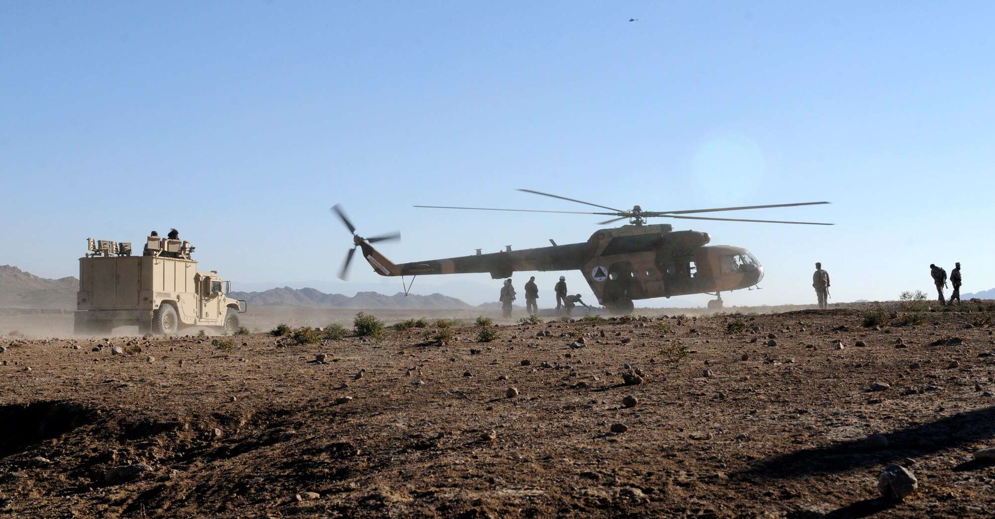 Afghan Air Force Kandahar Air Wing Mi-17 helicopter crew members and Afghan Border Police deliver humanitarian aid to the village of Gagre Naw, Afghanistan, during Operation Southern Strike IV, Nov. 18, 2012. (U.S. Army Photo/Staff Sgt. Ryan Sheldon)