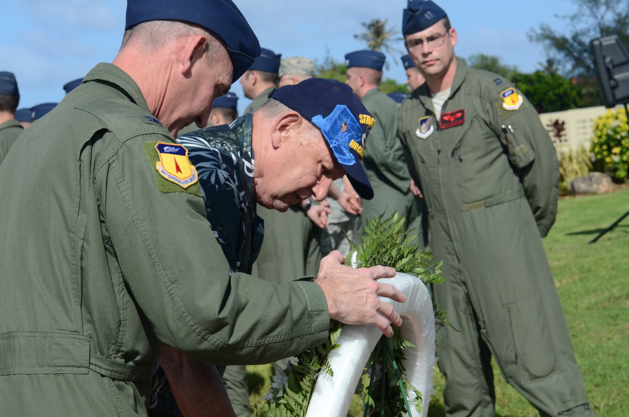 Senior Master Sgt. (ret.) Gary “Boomer” Adams lays the ceremonial wreath with Col. Randy Kaufman, 36th Operations Group commander, during the Operation Linebacker II Remembrance Ceremony at Andersen Air Force Base, Guam, Dec. 14. The ceremony commemorated the 40th anniversary of the Linebacker II campaign that led to the end of the Vietnam War. (U.S. Air Force photo by Senior Airman Benjamin Wiseman/Released)