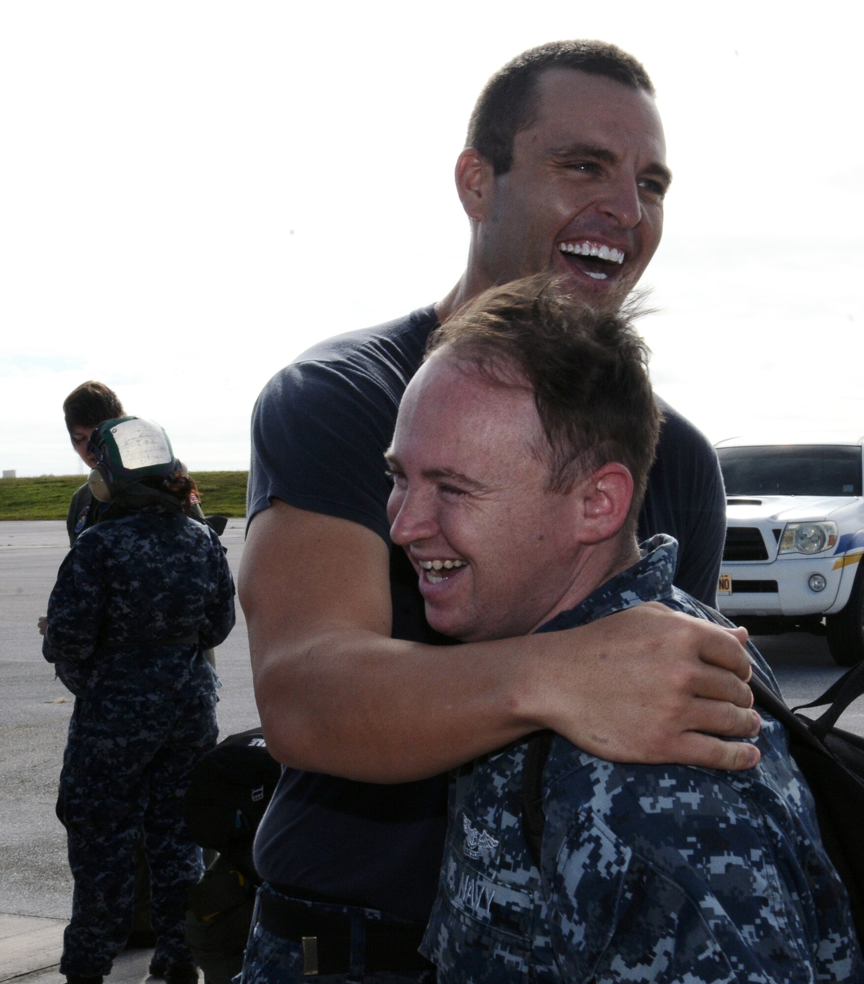 Avionic electronic technician 2nd Class William Luedecke, left, greets aviation ordinancemen 2nd Class Anthony Throesch during Helicopter Sea Combat Squadron TWO FIVE, greet each other upon the arrival of Detachment ONE at Andersen Air Force base, Guam, Dec. 13, 2012. While aboard the USNS Amelia Earhart (T-AKE 6), the detachment moved 3 million pounds of ordnance and cargo, supplying 37 missions and totaling 322 flight hours. Detachment ONE also conducted vertical replenishment operations in support of Commader, Task Force-73. (U.S. Air Force photo by Airman 1st Class Mariah Haddenham / Released)