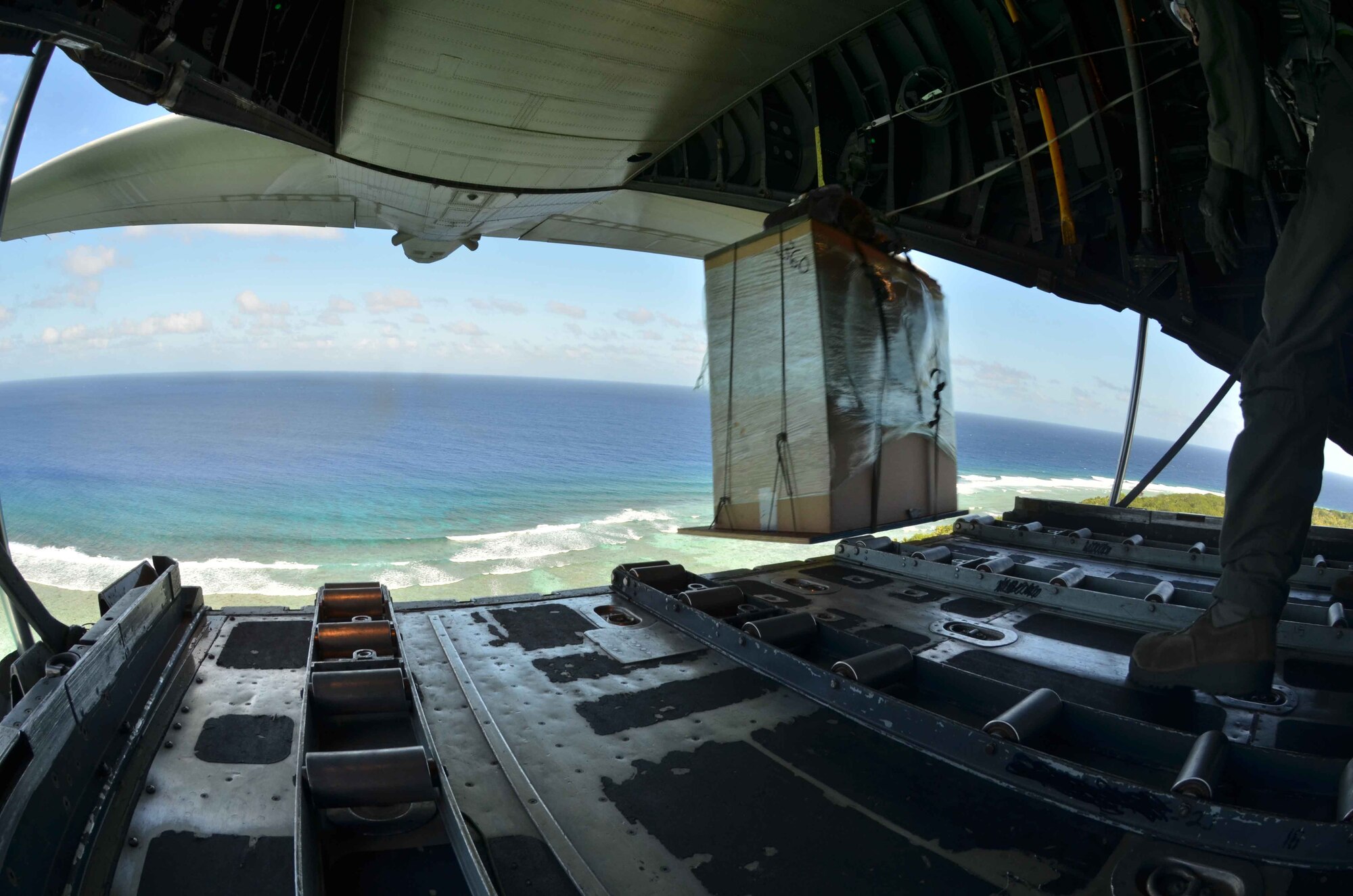 A box of humanitarian assistance goods is pushed out the back of a U.S. Air Force C-130 Hercules during an Operation Christmas Drop flight from Andersen Air Force Base, Guam, Dec. 14, 2012. Each year OCD provides aid to more than 30,000 islanders in Chuuk, Palau, Yap, Marshall Islands and Commonwealth of the Northern Mariana Islands. This year is the 61st anniversary of OCD, making it the longest running humanitarian mission in the world. In total, there are eight planned days of air drops, with 54 islands scheduled to receive humanitarian aid. (U.S. Air Force photo/Staff Sgt. Alexandre Montes/Released)