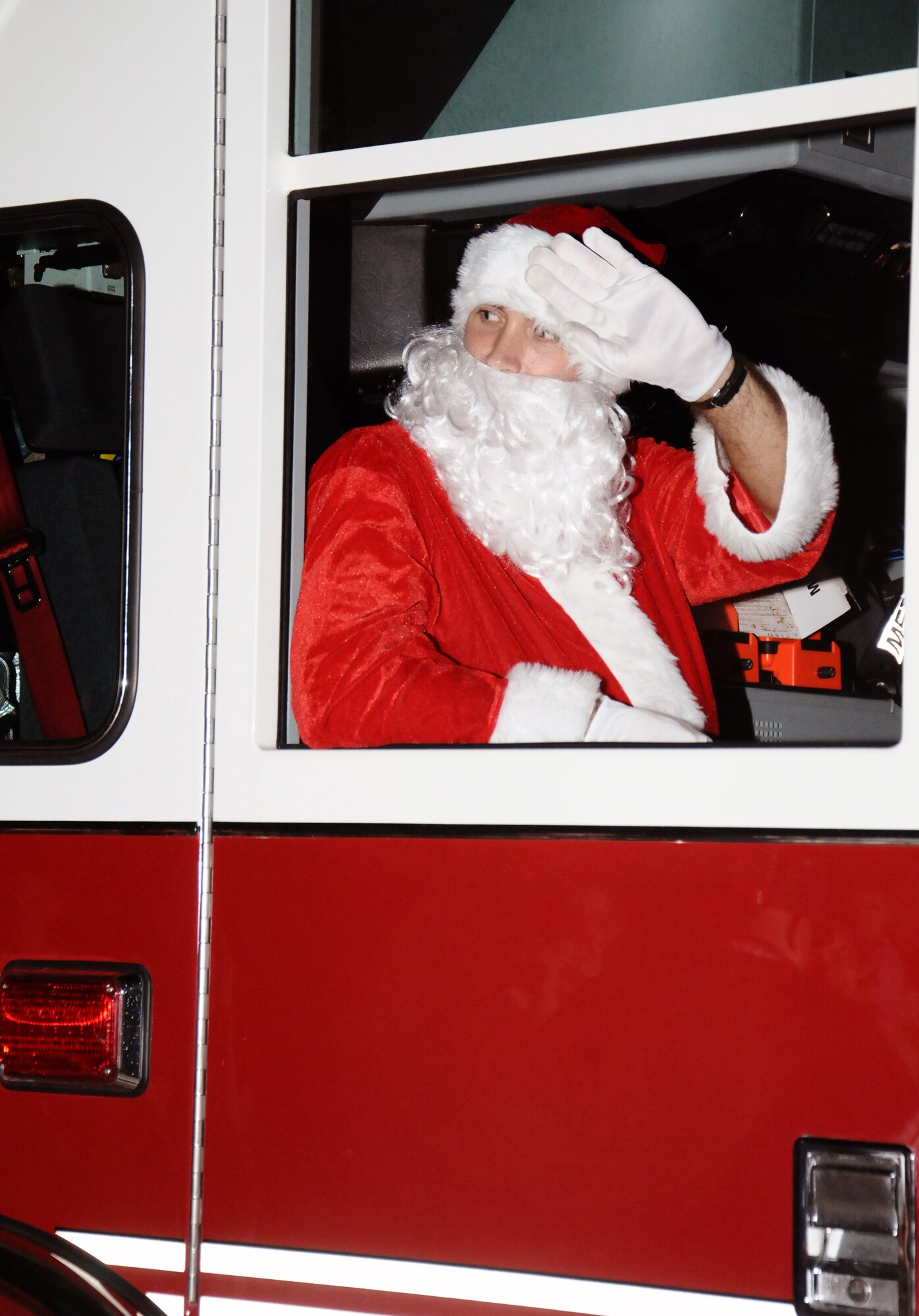Santa Claus waves to families attending the tree lighting ceremony on Andersen Air Force Base, Guam, Dec. 13, 2012. The ceremony also included the lighting of a Menorah and performances by the Cantate Choir, Andersen Elementary School and Andersen Gospel Choir. (U.S. Air Force photo by Airman 1st Class Mariah Haddenham/Released