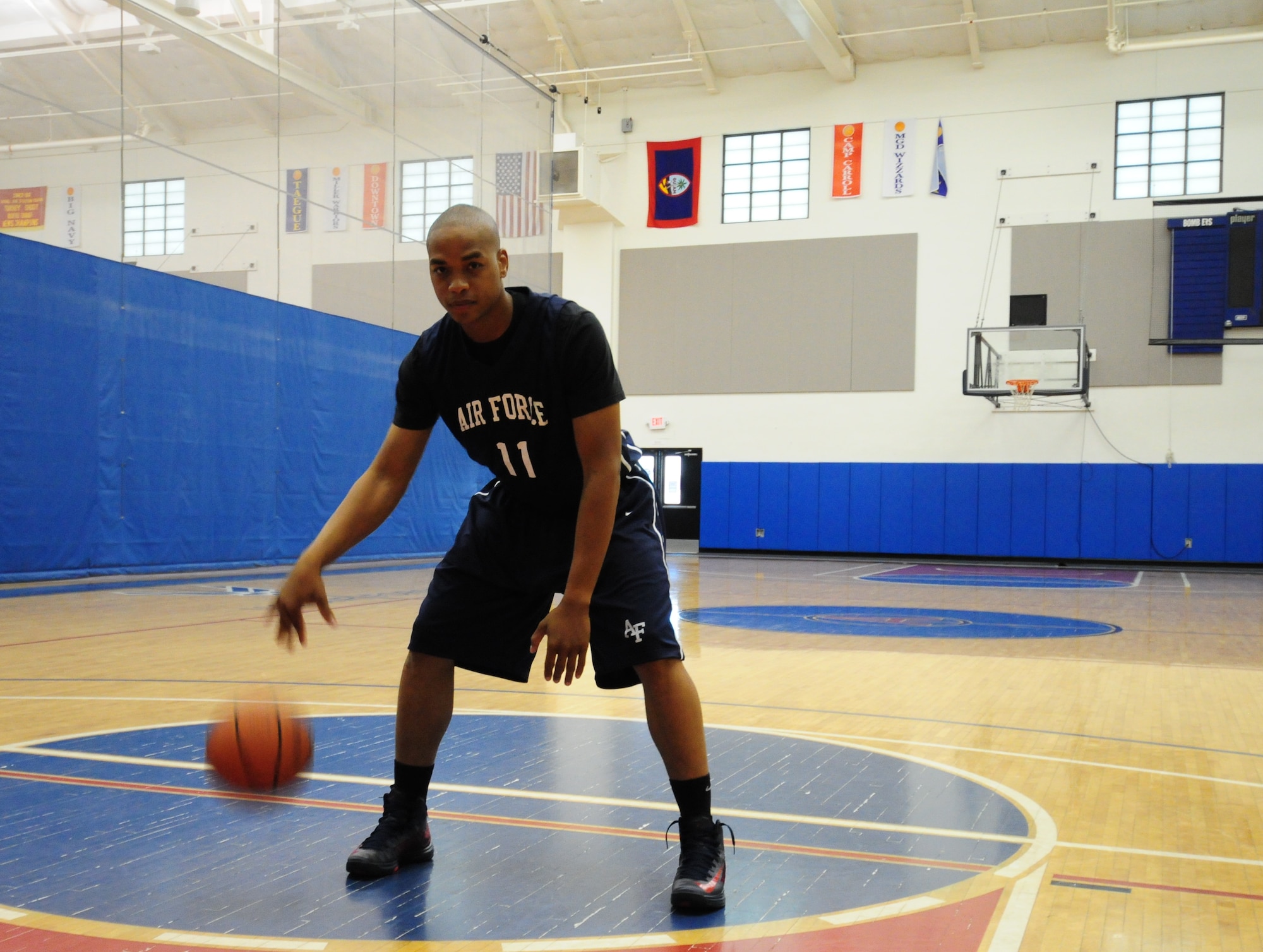 Staff Sgt. Ollie Bradley, 36th Security Forces Squadron flight chief, dribbles a basketball Dec. 11 at the Coral Reef Fitness Center, Andersen Air Force Base, Guam. For many years, he honed and perfected his skills, earning him a spot on the All Air Force team for the fifth time in his Air Force career. Sergeant Bradley has earned four gold medals and three appearances on the Armed Forces basketball team. (U.S. Air Force photo/Senior Airman Robert Hicks/Released)