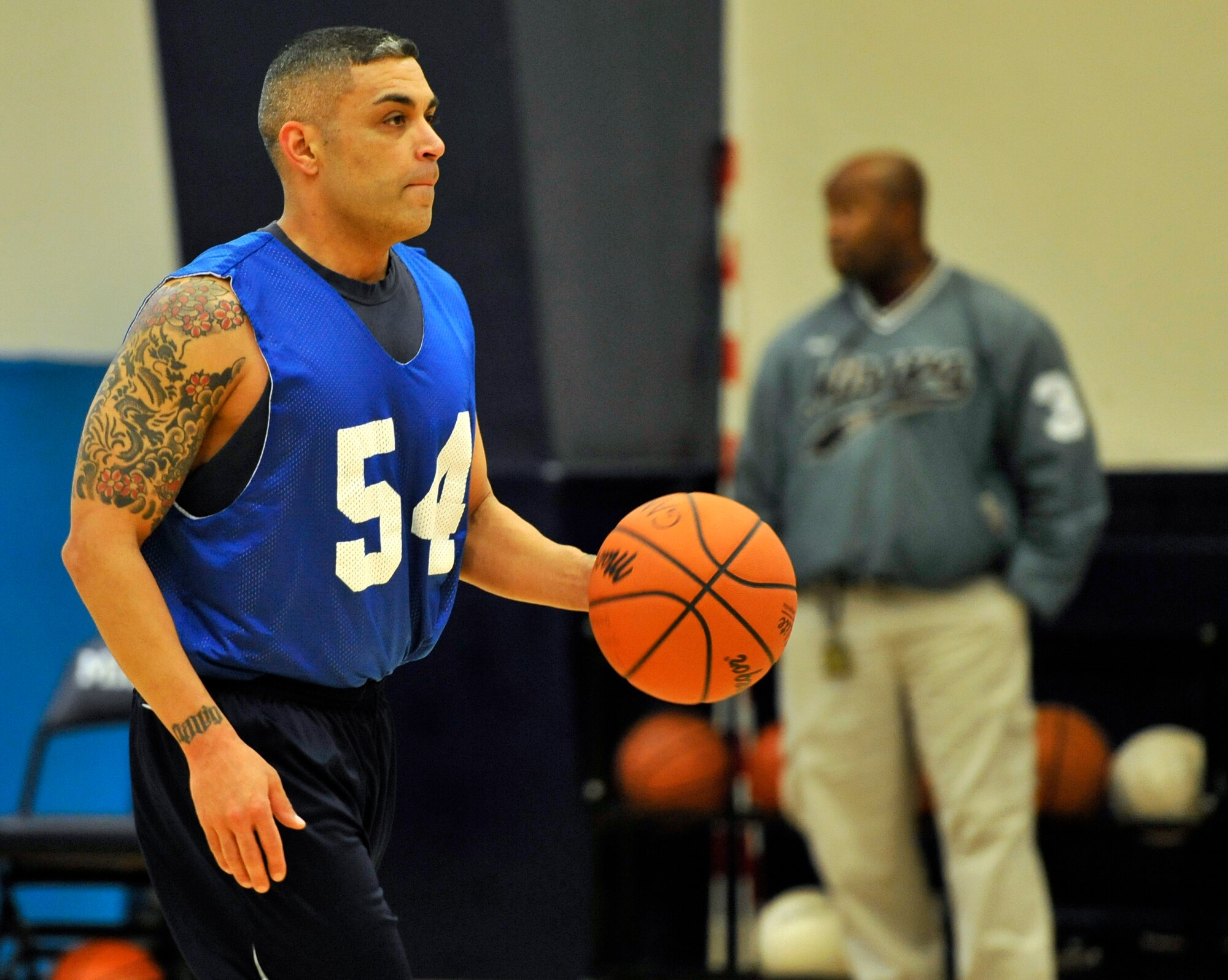 Rene Garza, 35th Civil Engineer Squadron Team B guard, looks for an open teammate during their game against the 35th Force Support Squadron at Misawa Air Base, Japan, Dec. 12, 2012. The game remained close the whole night, but the 35 FSS got the win over the 35 CES Team B by a score of 64-62. (U.S. Air Force photo by Airman 1st Class Zachary Kee)