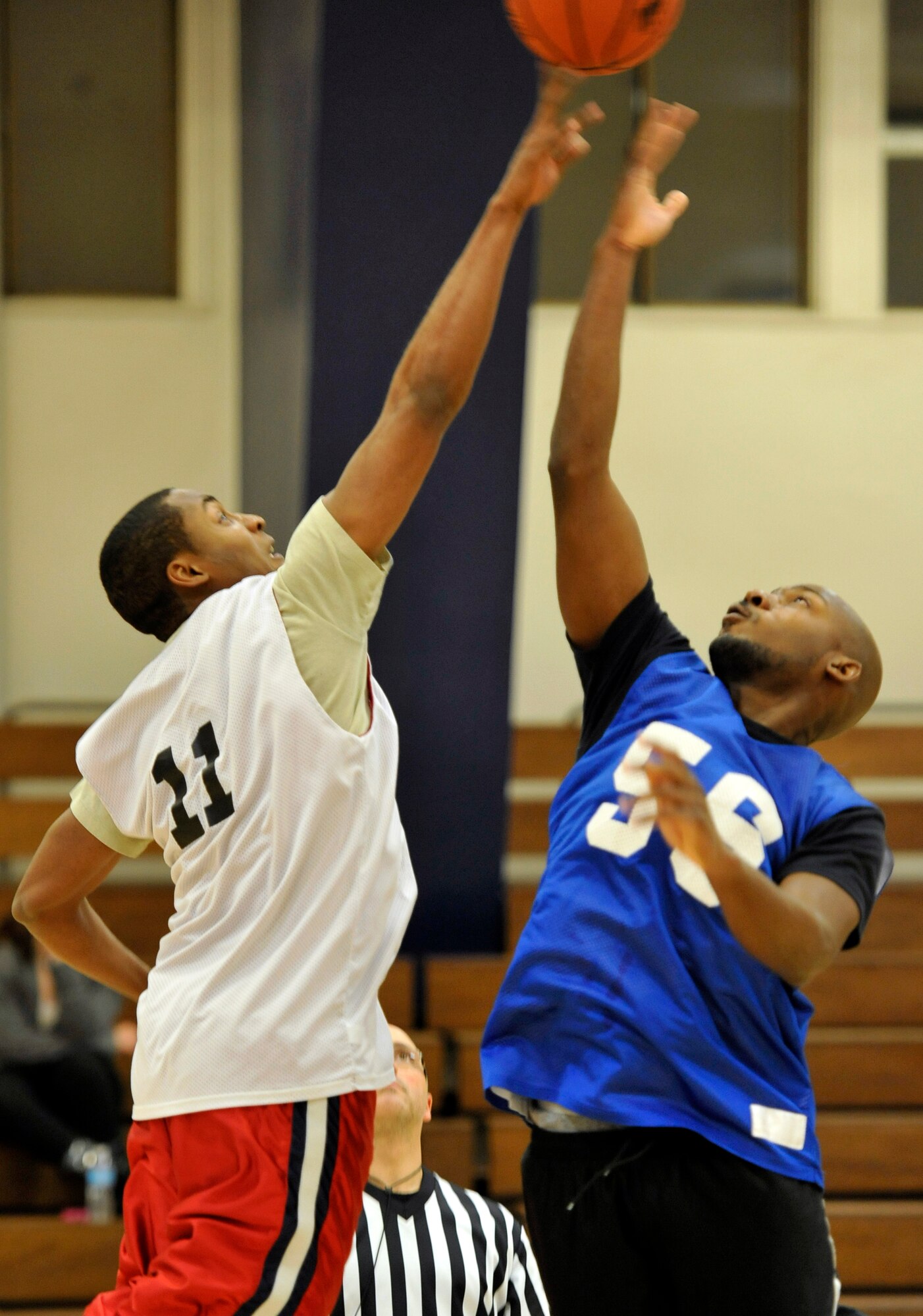 Players from the 35th Force Support Squadron and the 35th Civilian Engineer Squadron Team B fight for the tipoff during their game at Misawa Air Base, Japan, Dec. 12, 2012. The intramural basketball season started this week and offers action-packed games featuring units from around the base.  The season will continue through February with the playoffs starting toward the end of the month. (U.S. Air Force photo by Airman 1st Class Zachary Kee)