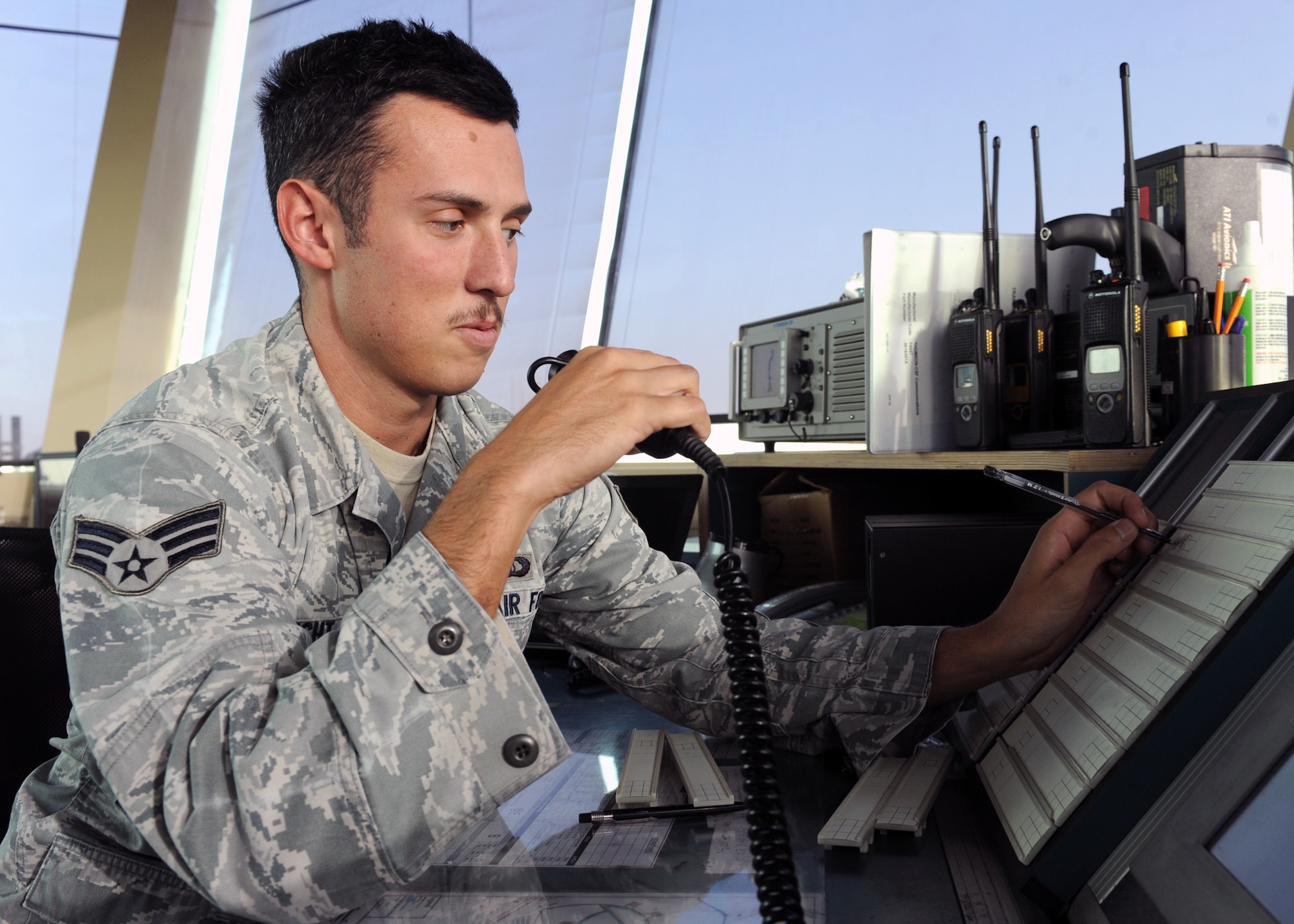 SOUTHWEST ASIA - Senior Airman William Wright, 379th Expeditionary Operations Support Squadron air traffic controller, updates the strip bay for an inbound aircraft Dec. 12. The strip bay helps the controllers keep track of air traffic by listing their call sign, requested altitude and other air management information. The left side of the bay keeps track of all inbound and the right all outbound aircraft. Wright is deployed from the 49th OSS at Holloman Air Force Base, N.M., and is a native of Houston. (U.S. Air Force photo/Senior Airman Joel Mease)