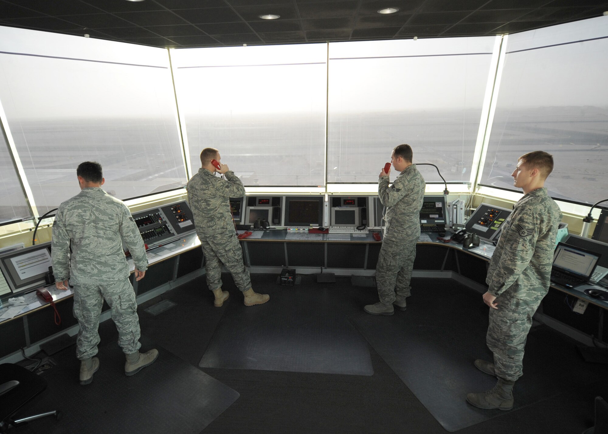 SOUTHWEST ASIA - Air traffic controllers assigned to the 379th Expeditionary Operations Support Squadron keep track of all aircraft in the vicinity of the airport Dec. 12. The air traffic control tower maintains operations 24 hours a day, 365 days a year. (U.S. Air Force photo/Senior Airman Joel Mease)