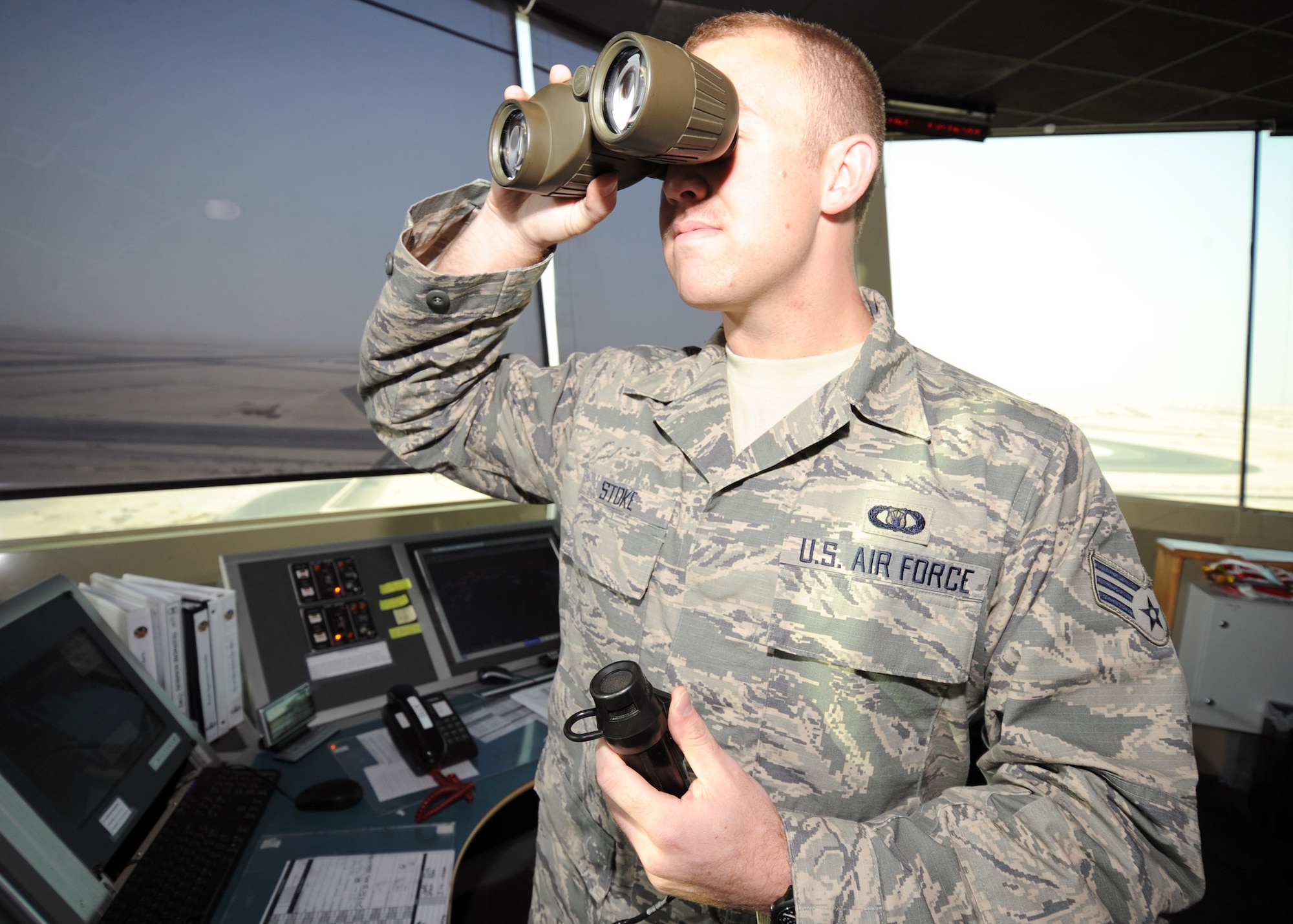 SOUTHWEST ASIA - Senior Airman John Stoke, 379th Expeditionary Operations Support Squadron air traffic controller, visually inspects the runway to ensure it is clear of vehicles and personnel. All obstructions can hinder an aircraft's ability to land. Stoke is deployed from the 19th OSS at Little Rock Air Force Base, Ark., and is a native of Jacksonville, Fla. (U.S. Air Force photo/Senior Airman Joel Mease)