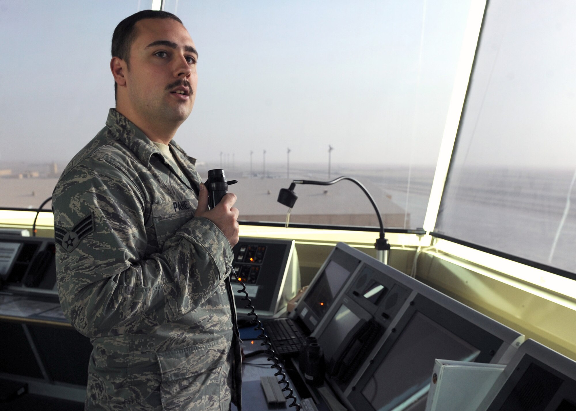 SOUTHWEST ASIA - Senior Airman Nicholas Pane, 379th Expeditionary Operations Support Squadron air traffic controller, issues traffic advisories between inbound aircraft in the vicinity of the airfield Dec. 12. Controllers use the tower display as a situational awareness tool to assist in and outbound aircraft. Pane is deployed from the 366th OSS at Mountain Home Air Force Base, Idaho, and is a native of Fort Calhoun, Neb. (U.S. Air Force photo/Senior Airman Joel Mease)