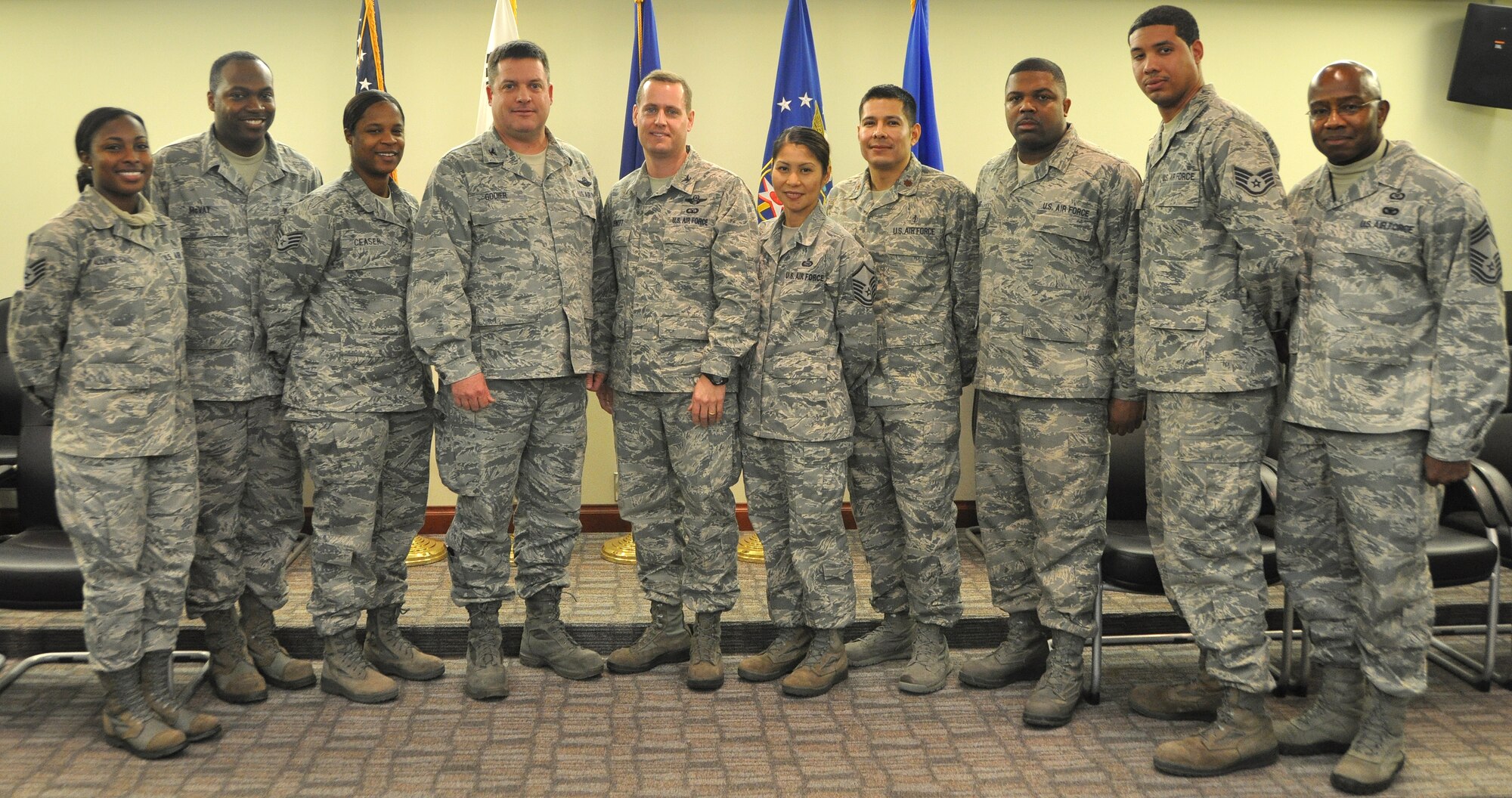 Osan leaders pose for a photo with the NCOs who went above and beyond to help a fellow Airmen with a personal battle. The eight NCOs were coined for their exemplary service Dec. 12, 2012 in the 7th Air Force conference room.  (U.S. Air Force photo/Senior Airman Kristina Overton)