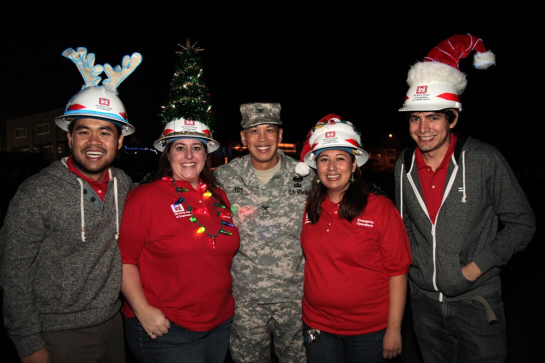 U.S. Army Corps of Engineers Los Angeles District making its first appearance in the annual Seal Beach Christmas Parade. Getting in the holiday spirit are from left to right: David Tran, Mindy Grupe, Col. Mark Toy, Noemi Rodriguez and Tito Carrillo. The parade made its way down historic Main Street in Old Town past kids of all ages Dec. 7.