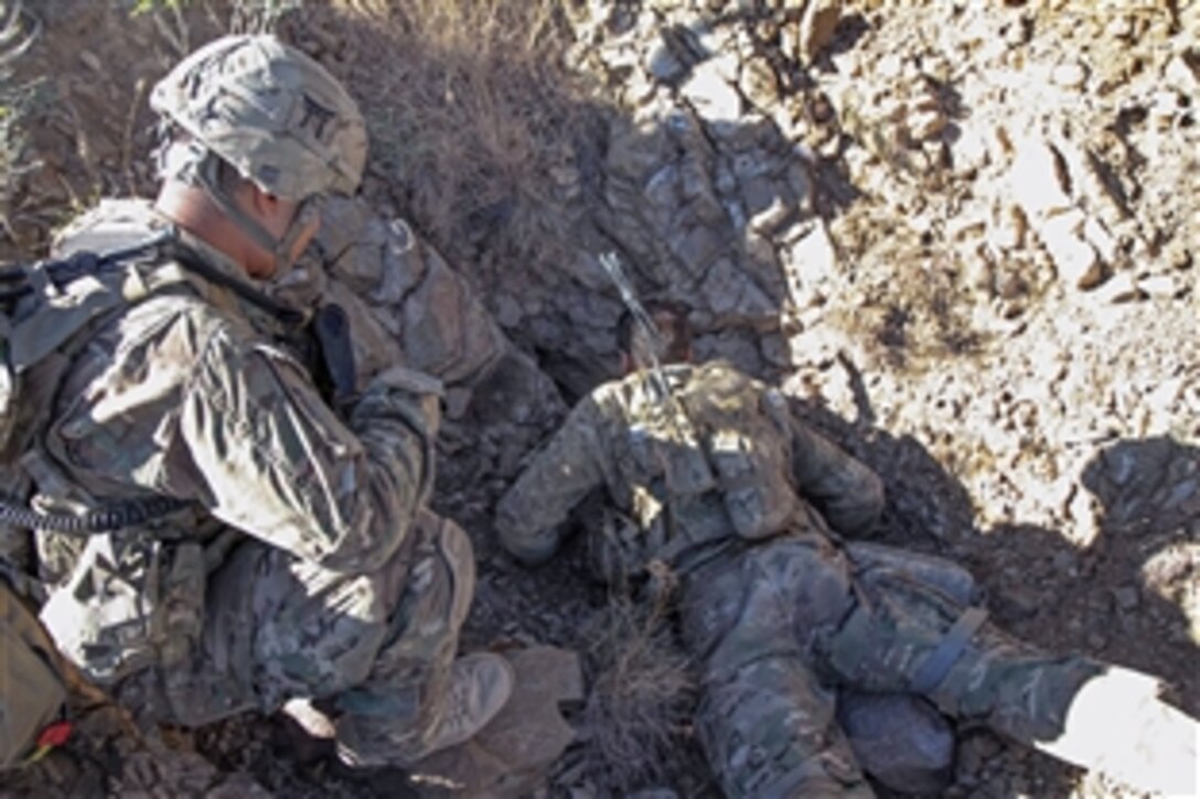 U.S. Army Sgt. Nathan Fleshman, right, investigates a small cave for weapons and insurgent activity near Combat Outpost Bowri Tana in eastern Afghanistan's Khowst province, Nov. 30, 2012. Fleshman is assigned to the 101st Airborne Division, Air Assault, Company C, 3rd Battalion, 187th Infantry Regiment, 3rd Brigade Combat Team. The soldiers were searching for where a rocket was fired from during a recent attack on their combat outpost.