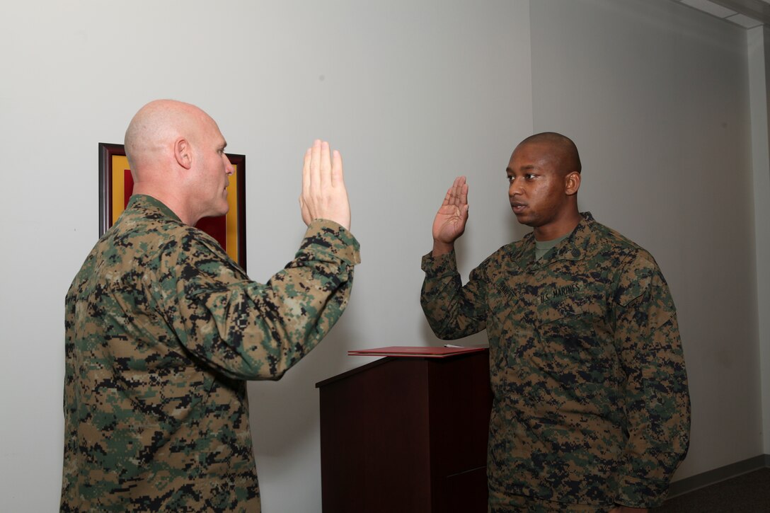 The 17th Sergeant Major of the Marine Corps, Sergeant Major Michael P. Barrett promotes Adrian Bennett from Sergeant to Staff Sergeant at Conde Hall, Marine Corps Base Quantico, on December 5, 2012. (Official U.S. Marine Corps photo by Sergeant Christopher A. Green) [Not Released]
