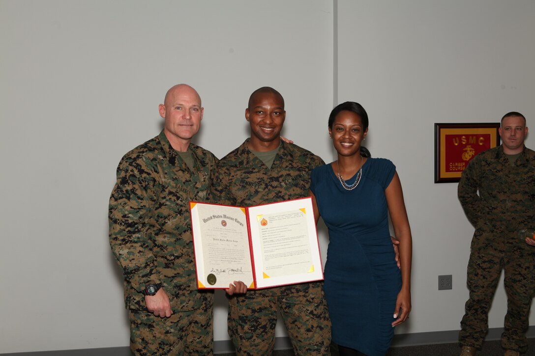 The 17th Sergeant Major of the Marine Corps, Sergeant Major Michael P. Barrett promotes Adrian Bennett from Sergeant to Staff Sergeant at Conde Hall, Marine Corps Base Quantico, on December 5, 2012. (Official U.S. Marine Corps photo by Sergeant Christopher A. Green) [Not Released]