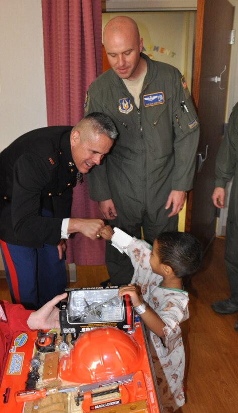Service members from Youngstown Air Reserve Station, Ohio (YARS) give a 1/100th scale C-130 aircraft model to a patient at Akron Children’s Hospital Mahoning Valley, Dec. 16. Four service members delivered the models and other toys to children for the holidays as part of the air station’s ongoing community outreach program and the Marine Corps Toys for Tots campaign. Col. Mark Ables, Capt. Brian Hodor and Master Sgt. Scott Francesangeli, members of the 757th Airlift Squadron, represented the Air Force Reserve, while Chief Warrant Officer 4 Emiliano DeLeon, commander of the Marine Corp Reserve Landing Support Equipment Company, based at YARS, represented the Marine Corp Reserve. YARS works closely with ACHMV to select candidates for the 910th Airlift Wing’s Pilot for a Day program, which welcomes children with chronic or life-threatening illnesses to the installation to be commissioned as an honorary second lieutenant, see various work centers and taxi aboard a C-130 Hercules aircraft. Youngstown Air Reserve Base Community Council, the 910th’s biggest non-profit supporter donated the C-130 models, while other toys came from Toys for Tots donations.