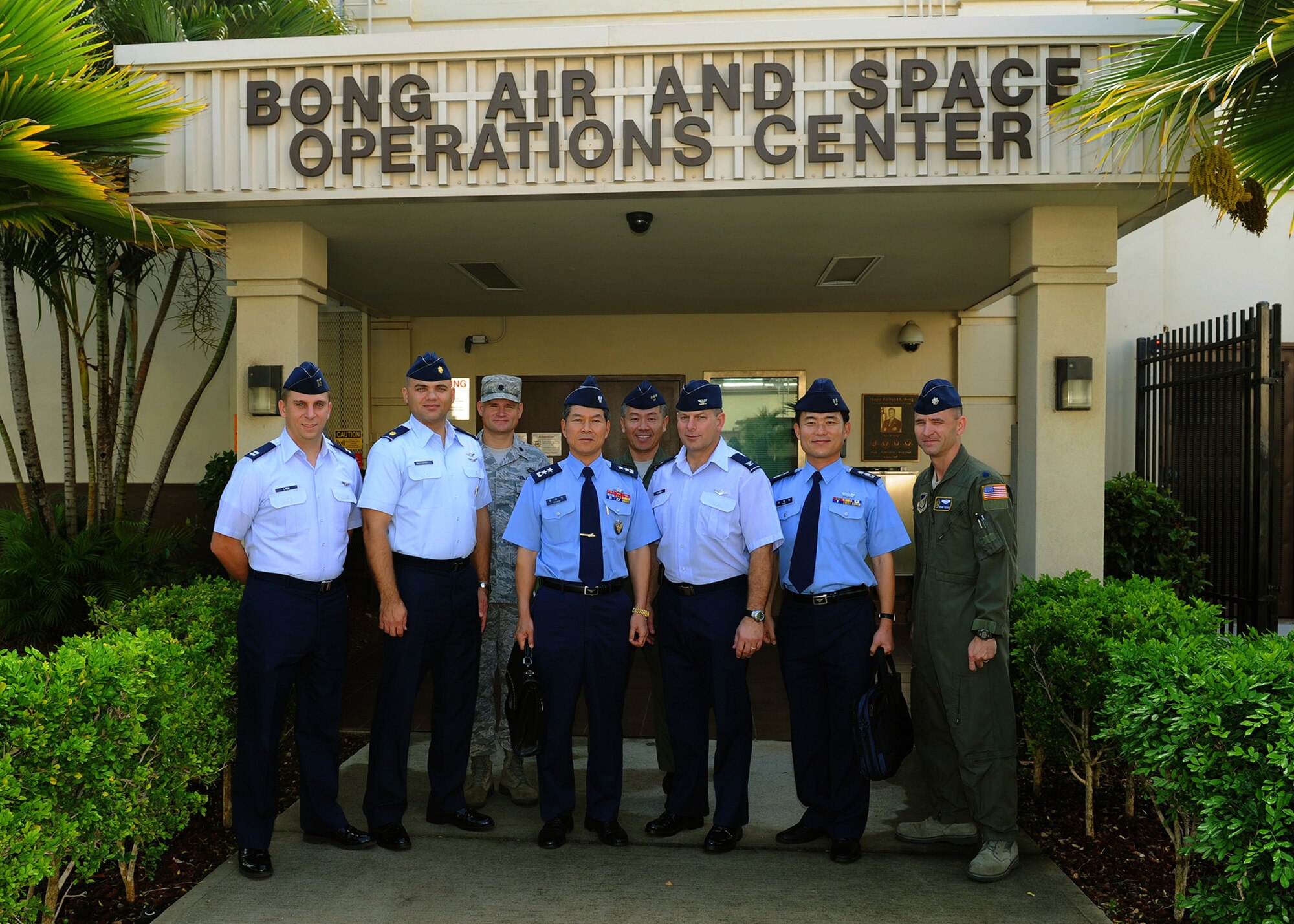 Maj. Gen. Kyeong-Doo Jeong, Defensive Counter Space Planning, Republic of Korea Air Headquarters (left center), and Col. James Mackay, mobilization assistant to the director for Operations, Plans, Requirements and Programs at Pacific Air Forces, (right center), poses for a group photo with members of their staffs in front of the 613th Air Operations Center, Joint Base Pearl Harbor-Hickam, Hawaii, Dec. 7, 2012. Jeong and his staff visited Hawaii to meet with PACAF personnel to discuss space relevant topics. (U.S. Air Force photo/Tech. Sgt. Jerome S. Tayborn)