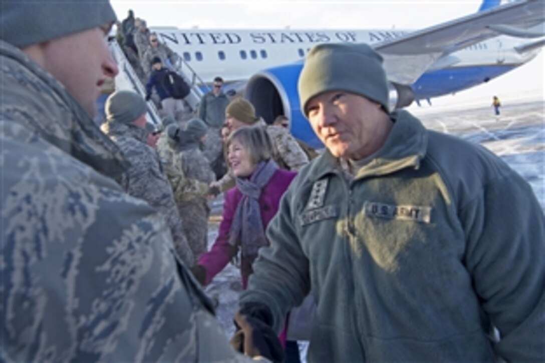 U.S. Army Gen. Martin E. Dempsey, chairman of the Joint Chiefs of staff, and his wife, Deanie, greet service members during a stop at the Transit Center in Manas, Kyrgyzstan, Dec. 14, 2012. Dempsey is visiting Manas during the USO Holiday Tour.