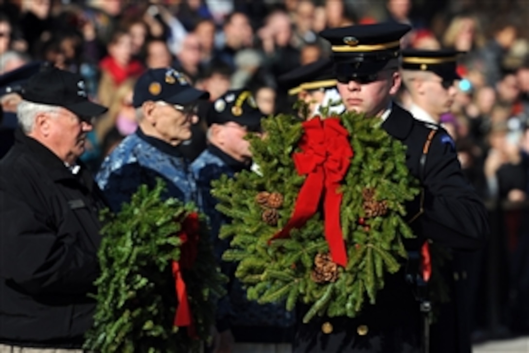 A member of the U.S. Army Honor Guard, 3rd U.S. Infantry Regiment, carries a wreath donated by Wreaths Across America at the Tomb of the Unknown Soldier at Arlington National Cemetery in Arlington, Va., Dec. 15, 2012.