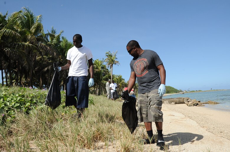 Airman 1st Class Gregory Jones-Fields, (left), and Airman 1st Class Keith Kennedy, both weapons personnel from the 36th Maintenance Squadron, participate in a beach cleanup at Asan Beach, Guam, Dec. 7, 2012, as part of their Weapons Day of Caring. The cleanup was organized in remembrance of the attacks on Pearl Harbor Dec. 7, 1941. (U.S. Air  Force photo by Airman 1st Class Adarius Petty/Released)
