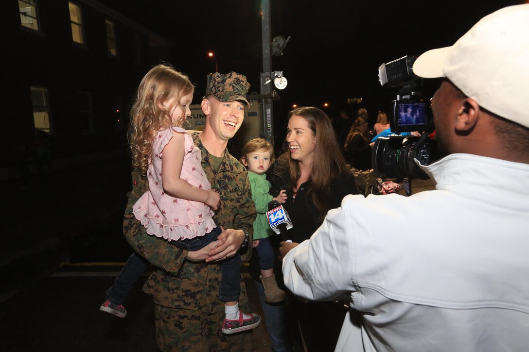 MARINE CORPS BASE CAMP LEJEUNE, N.C. – A Marine with Charlie Company, Battalion Landing Team 1st Battalion, 2nd Marine Regiment, 24th Marine Expeditionary Unit conducts an interview with his family and a local news reporter after returning home from deployment on Camp Lejeune, Dec. 16, 2012. The 24th Marine Expeditionary Unit has returned to the U.S. after completing nearly nine months deployed as an expeditionary crisis response force with the Iwo Jima Amphibious Ready Group.   Approximately 2,300 Marines and Sailors of the 24th MEU will be offloading over the next few days from amphibious assault ships USS Iwo Jima, USS New York and USS Gunston Hall. (Official U.S. Marine Corps Photo by Sgt. Richard Blumenstein)