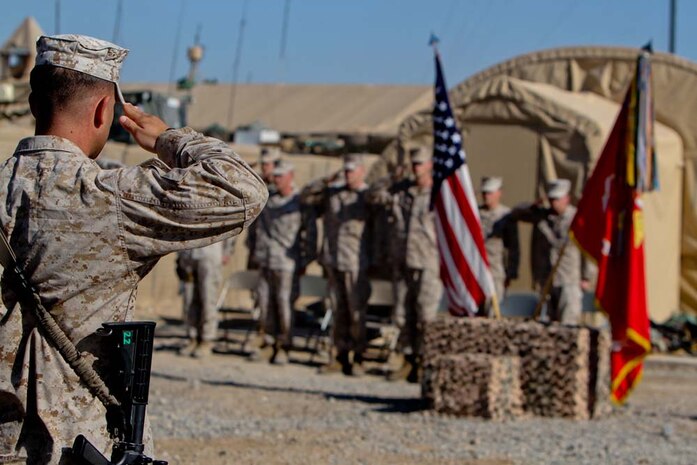Sergeant Austin Perry, squad leader, India Company, 3rd Battalion, 9th Marine Regiment, Regimental Combat Team 7, renders a salute at the beginning of a memorial service honoring Lance Cpl. Anthony Denier, Dec. 8, 2012. Denier, a rifleman with the battalion, died while conducting combat operations in Marjah, Afghanistan, Dec. 2, 2012.