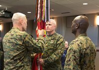 NORFOLK - Lt. Gen. John Paxton passes the command colors to Brig. Gen. W. Blake Crowe during a succession of command ceremony aboard Naval Support Activity Hampton Roads Dec. 13. Crowe is expected to fill the position as commander of Marine Corps Forces Command and Fleet Marine Forces Atlantic until a replacement is nominated and confirmed.