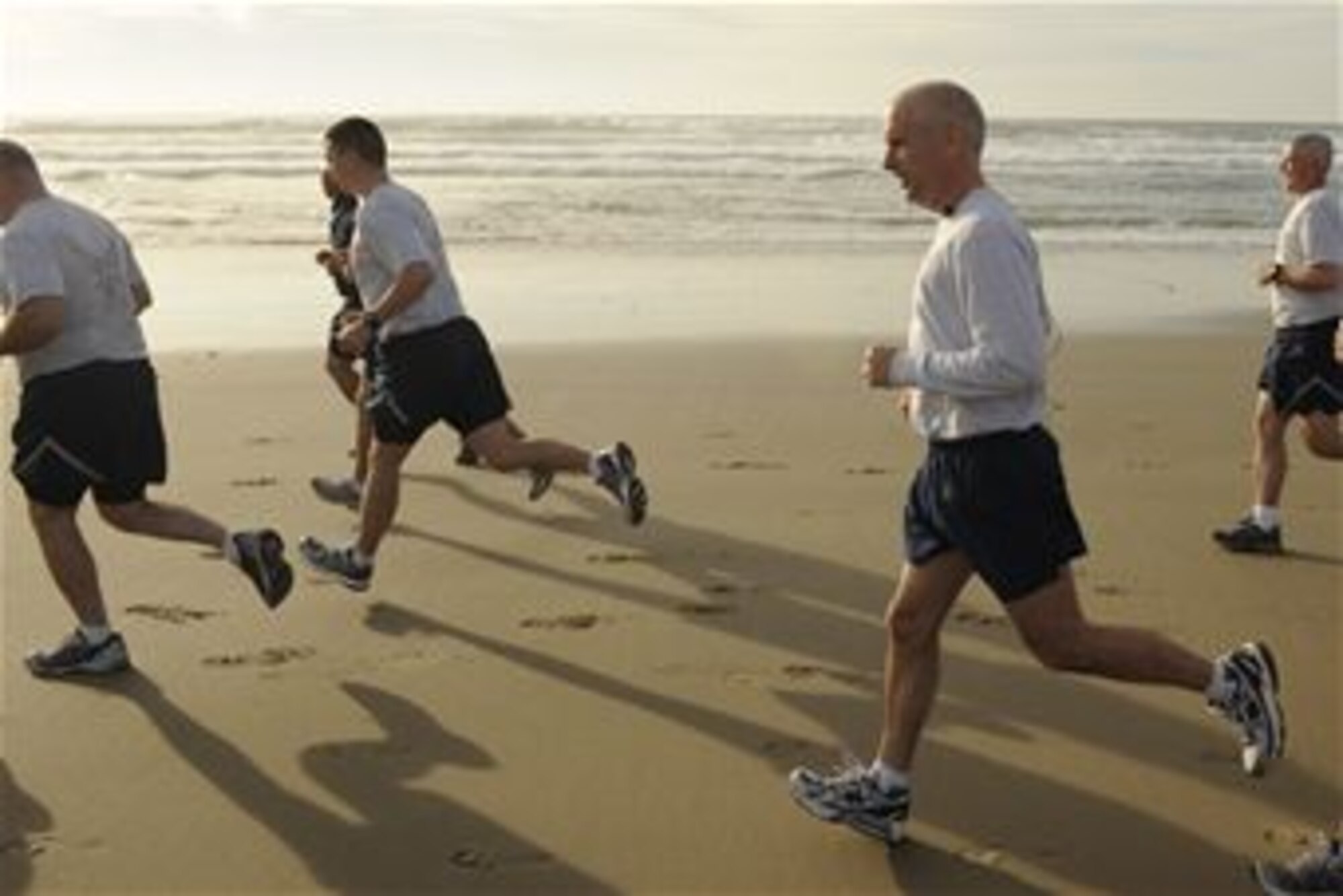 VANDENBERG AIR FORCE BASE, Calif. -- Col. Richard Boltz, 30th Space Wing commander, runs with Team V members during his final run as commander on Wall Beach here Wednesday, Jan. 11, 2012. More than 80 Vandenberg members ran three miles with the commander as a farewell gesture for him. (U.S. Air Force/Staff Sgt. Levi Riendeau)