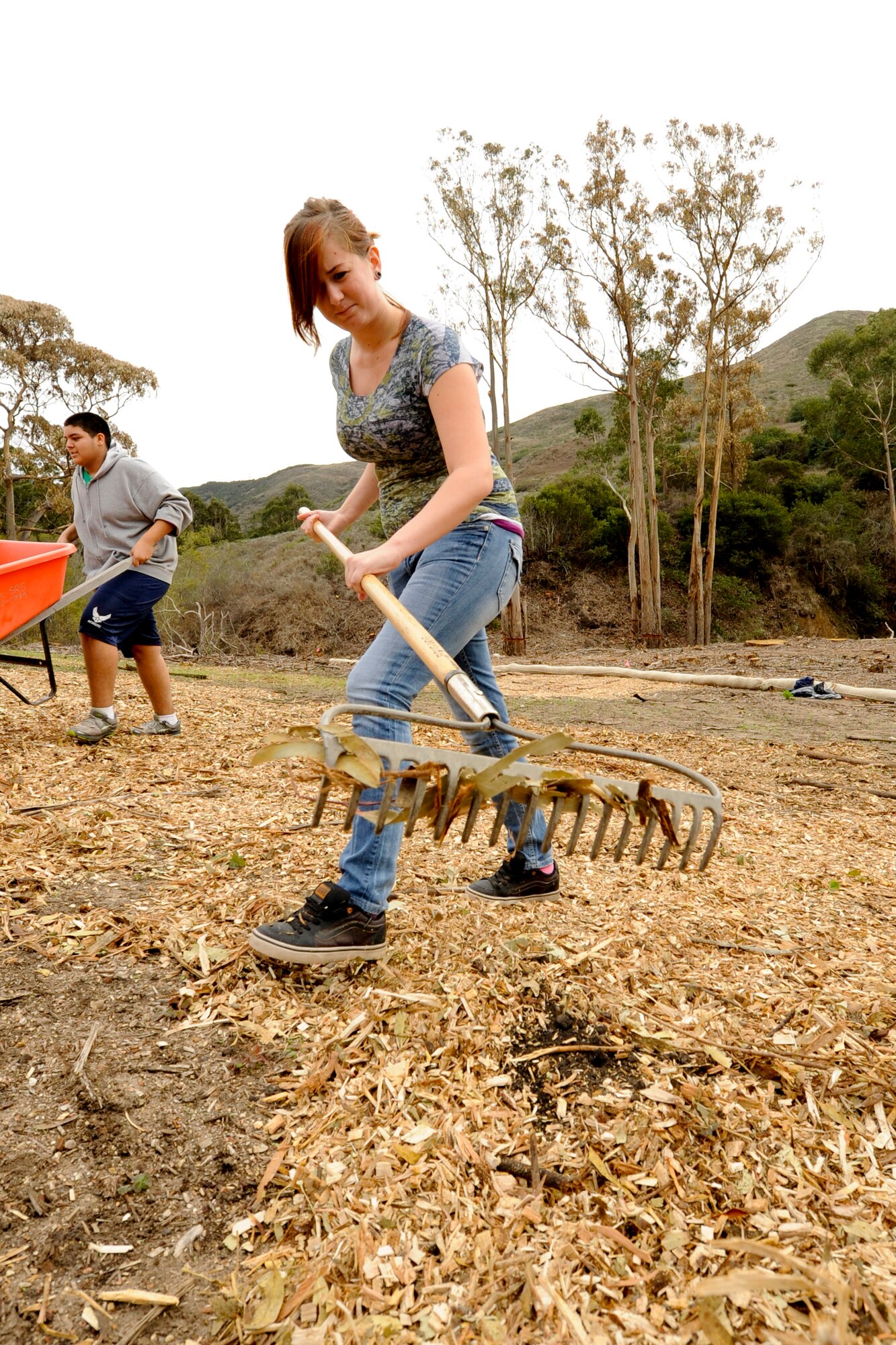 VANDENBERG AIR FORCE BASE, Calif. -- Savanna Ferguson, a Bakersfield High School Air Force Junior Reserve Officers' Training Corps cadet, spreads mulch at Honda Creek on South base here Friday, Dec. 14, 2012. The cadets came to Vandenberg to provide community service to the installation as part of their duties in JROTC. (U.S. Air Force photo/Staff Sgt. Levi Riendeau)