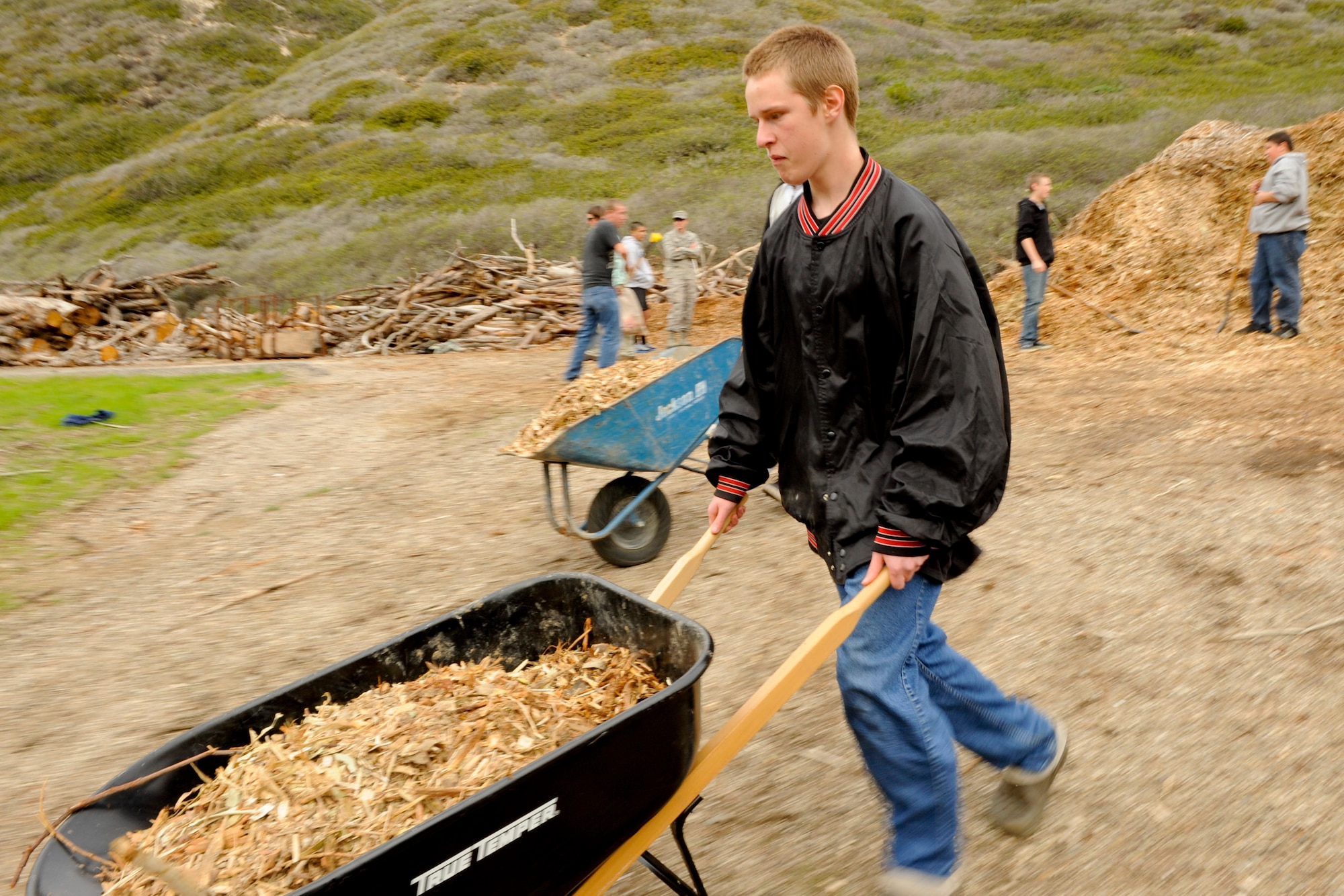 VANDENBERG AIR FORCE BASE, Calif. -- Stoney Frazier, a Bakersfield High School Air Force Junior Reserve Officers' Training Corps cadet, moves mulch to be spread at Honda Creek on South base here Friday, Dec. 14, 2012. The cadets came to Vandenberg to provide community service to the installation as part of their duties in JROTC. (U.S. Air Force photo/Staff Sgt. Levi Riendeau)