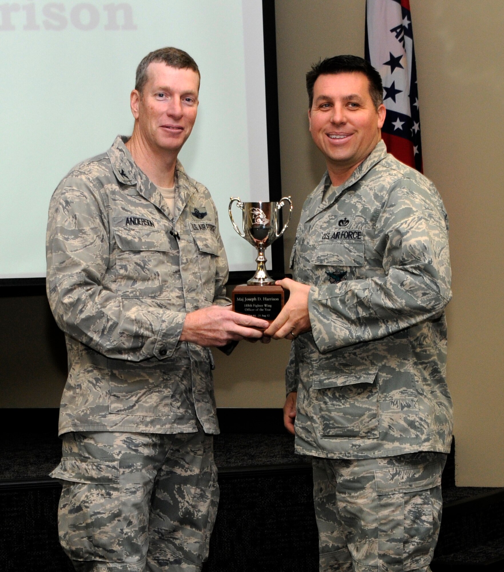 Col. Mark Anderson, 188th Fighter Wing commander, left, poses for a photo with Outstanding Officer of the Year, Maj. Joe Harrison, during a commander’s call Dec. 1 at the 188th. (National Guard photo by Amn Cody Martin/188th Fighter Wing Public Affairs)