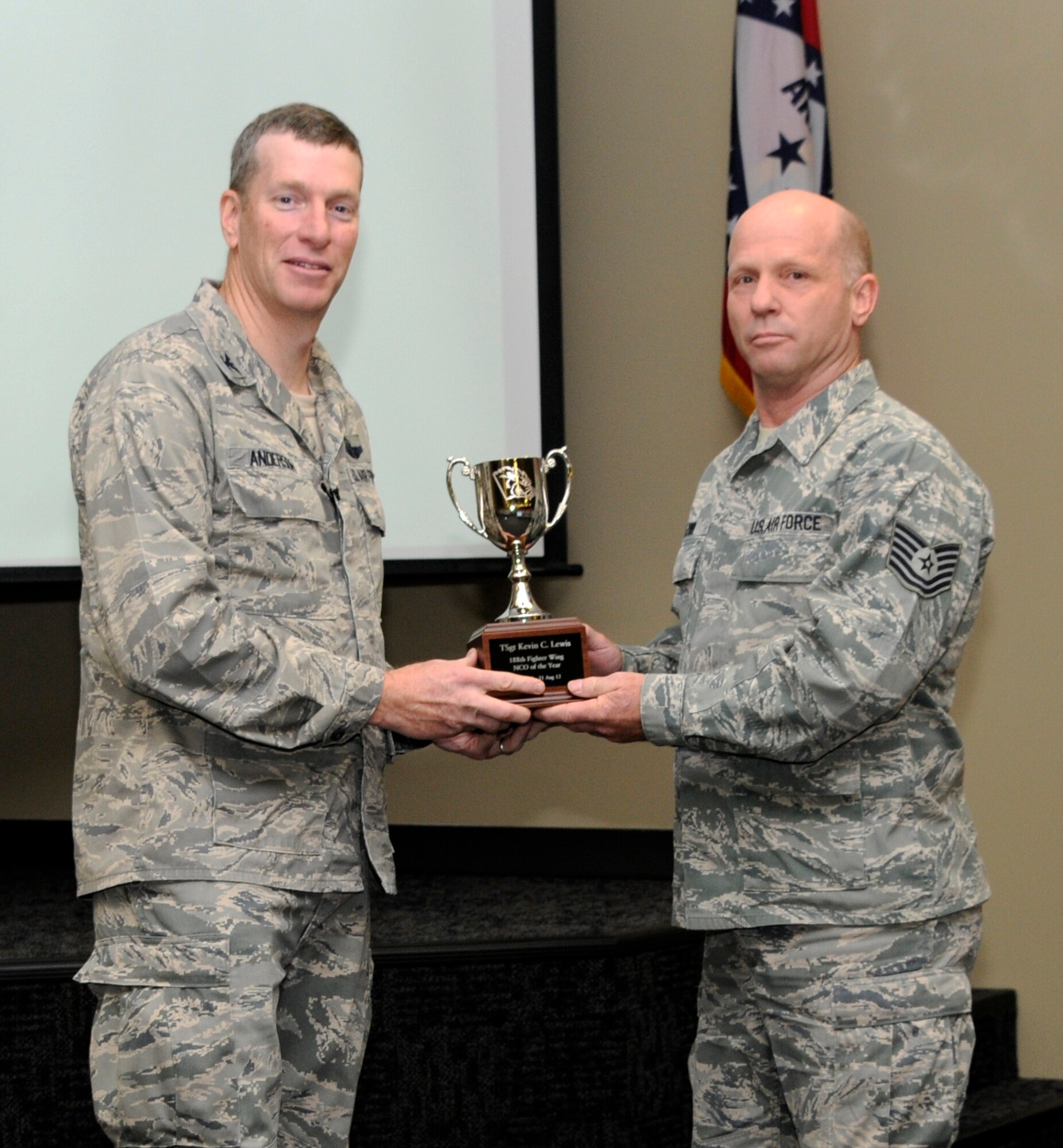 Col. Mark Anderson, 188th Fighter Wing commander, left, poses for a photo with Outstanding Noncommissioned Officer of the Year, Tech Sgt. Kevin Lewis, during a commander’s call Dec. 1 at the 188th. (National Guard photo by Amn. Cody Martin/188th Fighter Wing Public Affairs)