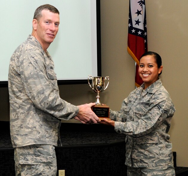 Col. Mark Anderson, 188th Fighter Wing commander, left, poses for a photo with Outstanding Airman of the Year, Airman 1st Class Delmy C. Osorio, during a commander’s call Dec. 1 at the 188th. (National Guard photo by Amn Cody Martin/188th Fighter Wing Public Affairs)