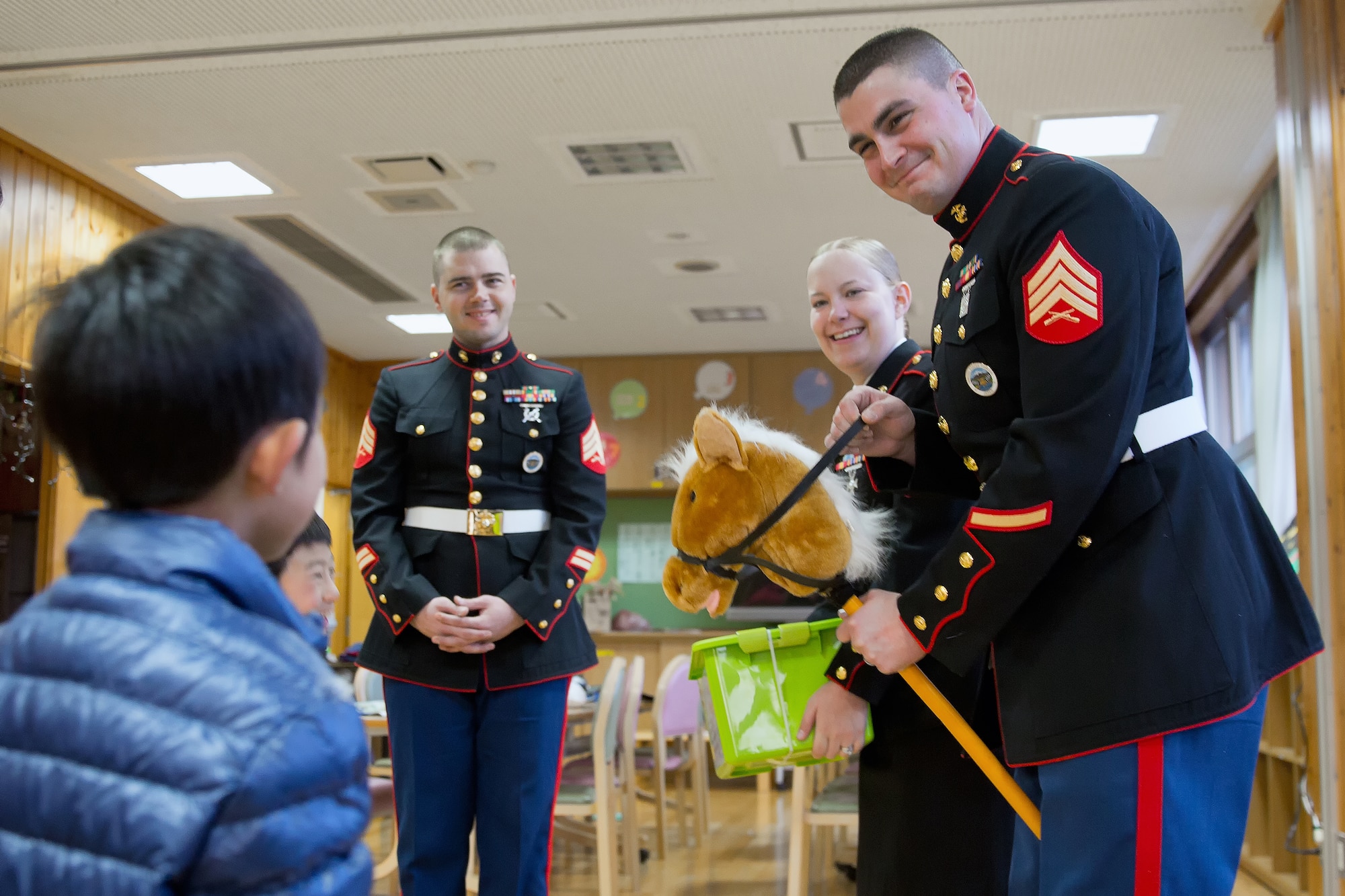 AKIRUNO CITY, Japan -- U.S. Marine Corps Sgt. Jeremiah Crane, right, U.S. Forces, Japan, explains how to use a horse toy to children at Ajiro orphanage in Akiruno city, Tokyo, Dec. 14, 2012 during the annual USMC Reserve Toys for Tots drive. In 1947, a group of U.S. Marine Reservists collected and distributed 5,000 toys to children in need on Christmas Eve in the Los Angeles area. The USMC has distributed more than 300 million toys to 150 million children. (U.S. Air Force photo by Osakabe Yasuo)