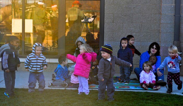 Children dance to holiday music performed by Travis Brass at the Child Development Center, Beale Air Force Base Calif., Dec. 13 2012. The band performs multiple holiday shows across the Western states. (U.S. Air Force photo by Staff Sgt. Robert M. Trujillo/Released)