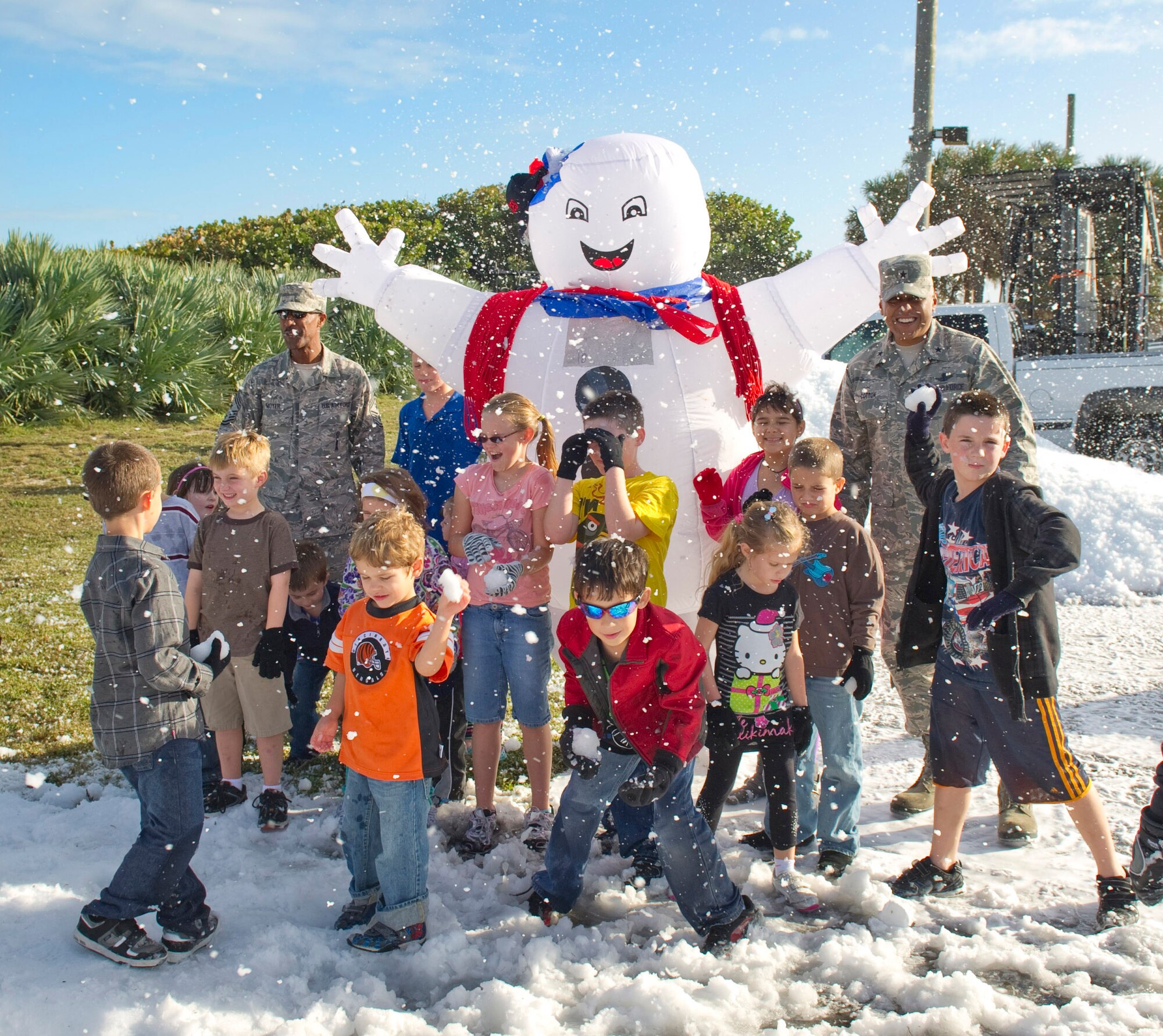 Brig. Gen. Anthony Cotton, commander, 45th Space Wing, and Chief Master Sgt. Herman Moyer, wing command chief, 45th Space Wing, enjoy real snow at the 45th Space Wing Holiday Party hosted by the 45th Force Support Squadron at the Tides Dec. 14, 2012. 