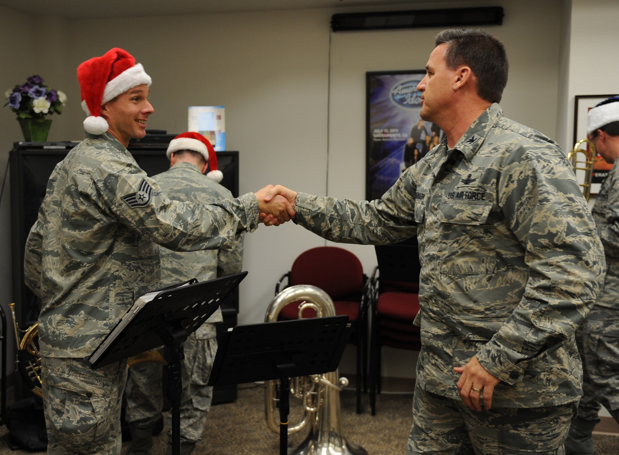 Col. Kevin Cavanagh, 940th Wing commander, shakes hands with Staff Sgt. Robbie Mayes, Band of the Golden West French horn player at Beale Air Force Base, Calif., Dec. 13, 2012. The band performed holiday music at the wing’s headquarters. (U.S. Air Force photo by Staff Sgt. Robert M. Trujillo/Released)