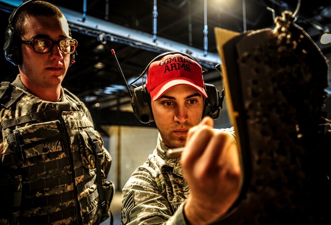 Staff Sgt. Eric Lawrence, 628th Security Forces Squadron Combat Arms Training and Maintenance instructor, counts the number of rounds that hit Senior Airman Joshua Buchanan’s, 628th SFS patrolman, target sheet during an M-4 carbine qualifying session at the CATAM firing range, Dec. 12, 2012, on Joint Base Charleston – Air Base, S.C. Airmen from the 628th SFS participated in the M-4 training overseen by CATM instructors. (U.S. Air Force photo/ Senior Airman Dennis Sloan)